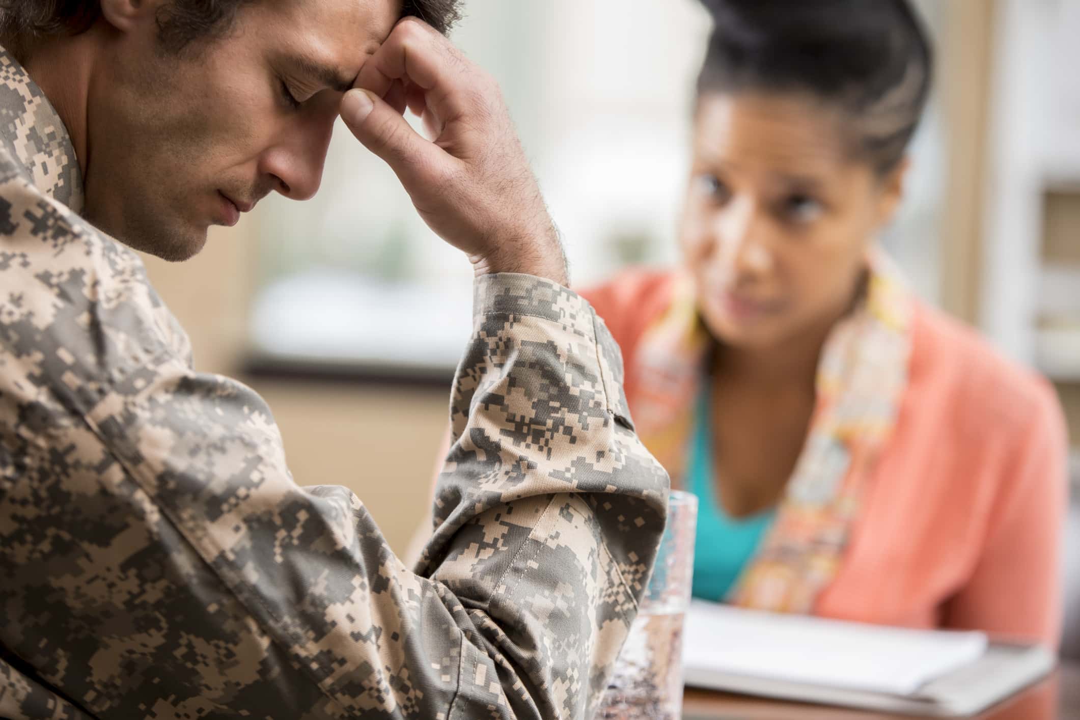 Depressed veteran meets with psychologist.