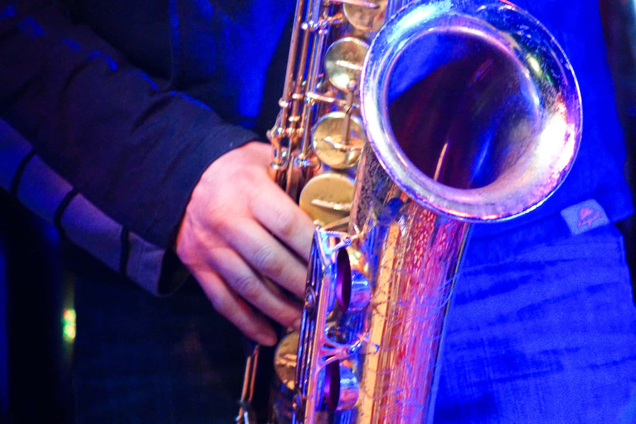 Midsection Of Musician Playing Saxophone During Music Concert