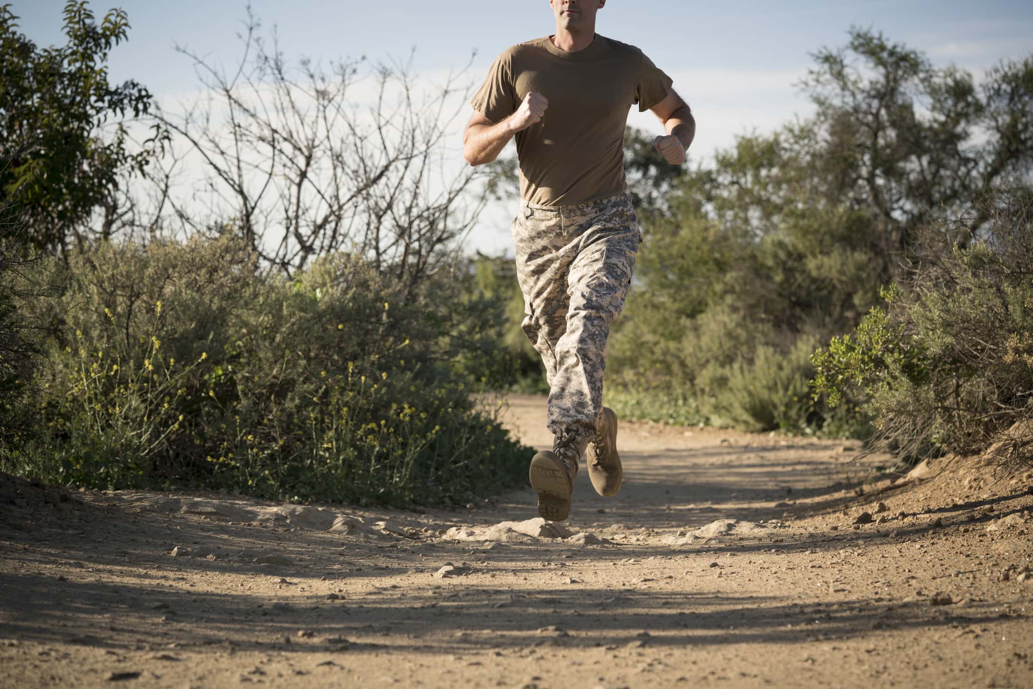 Soldier wearing combat clothing running, Runyon Canyon, Los Angeles, California, USA.