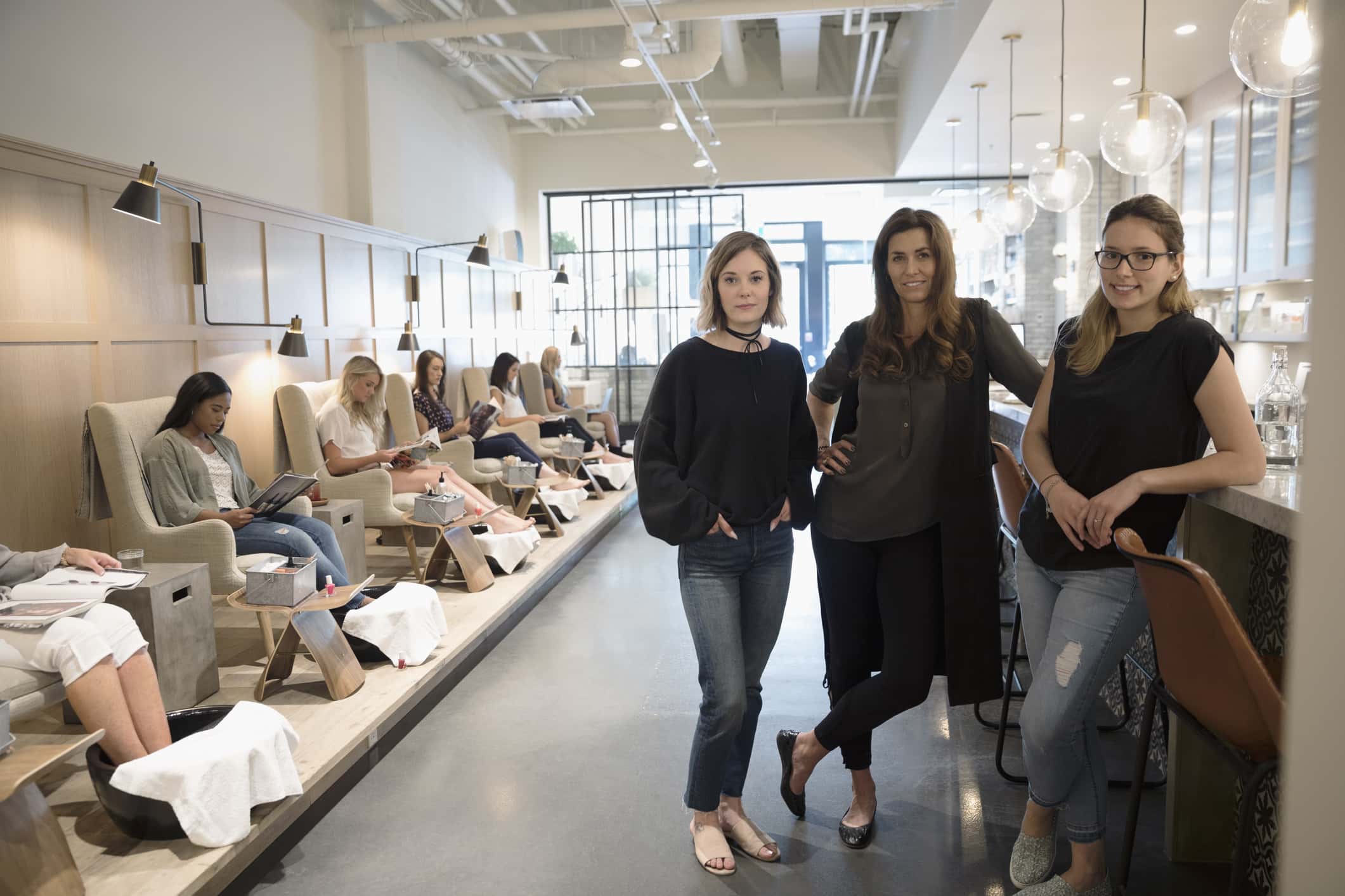 Nail technicians and shop owner in nail salon