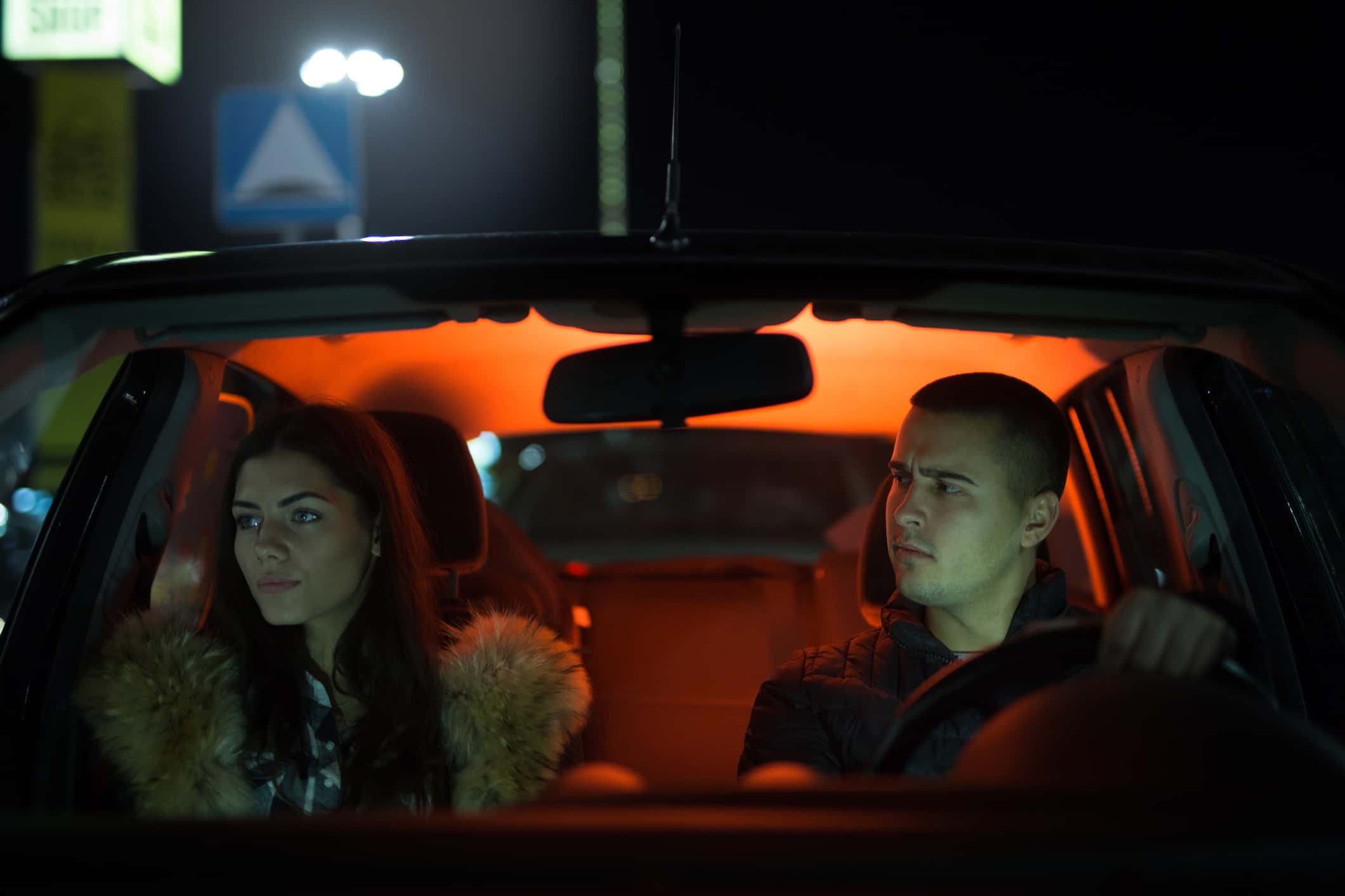 Couple arguing about something in a car.