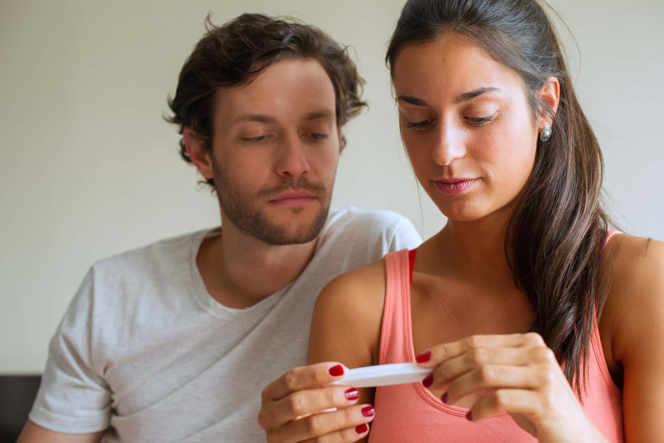 Couple looking at pregnancy test.