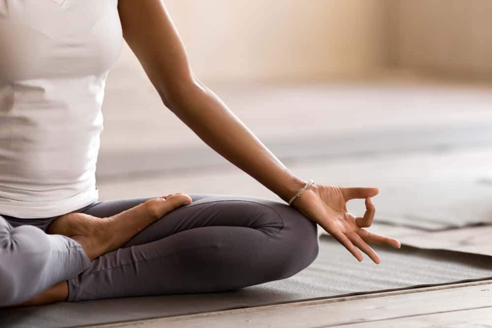 Woman practicing yoga at home.