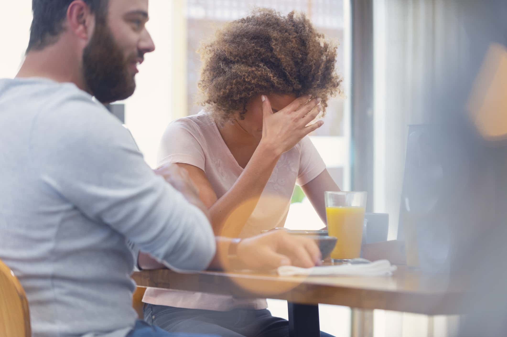 Couple arguing at the breakfast table.