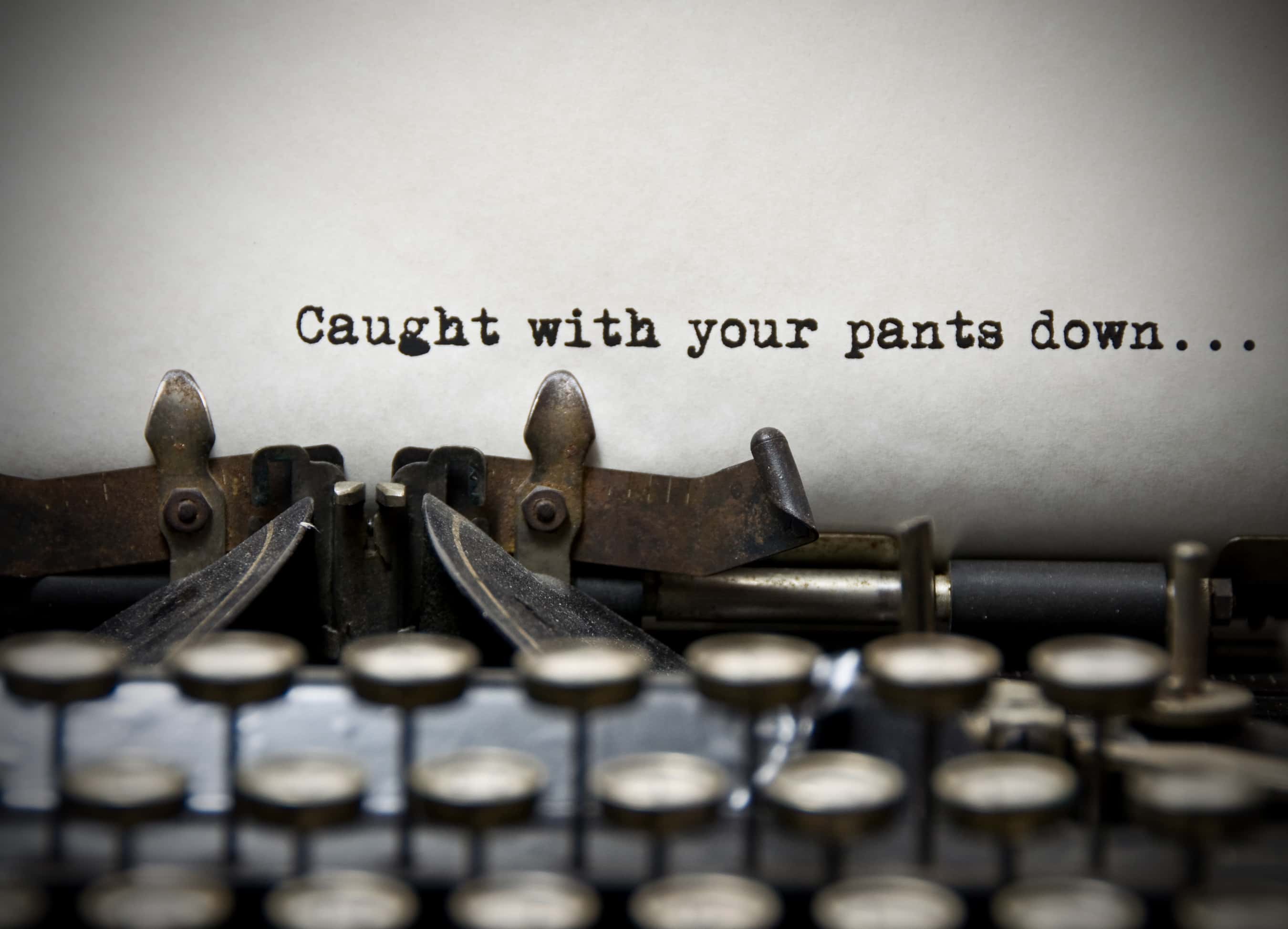 'Caught with Your Pants Down' quote on a typing machine.