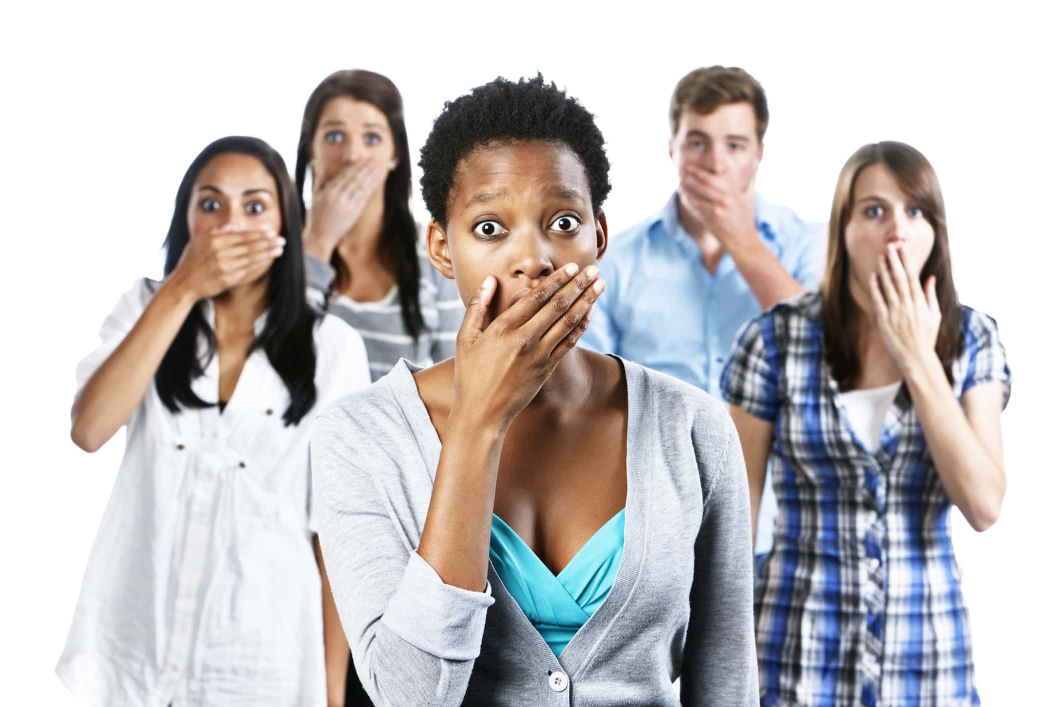 Five shocked young people with hands over their mouths.