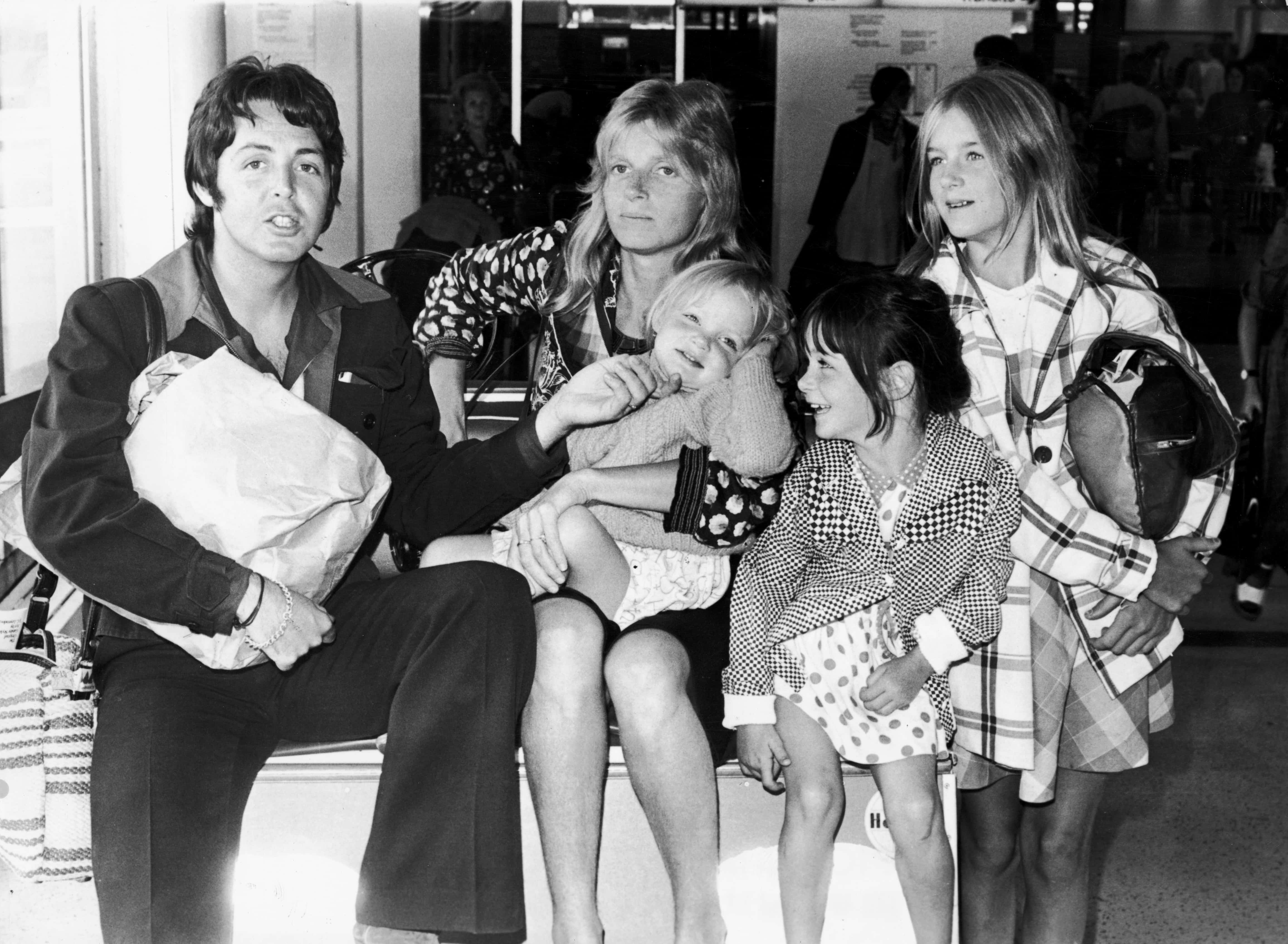 British singer and songwriter Paul McCartney poses with his wife Linda (1941 - 1998), and their daughters, left to right, Stella, Mary, and Heather, at Heathrow Airport in London