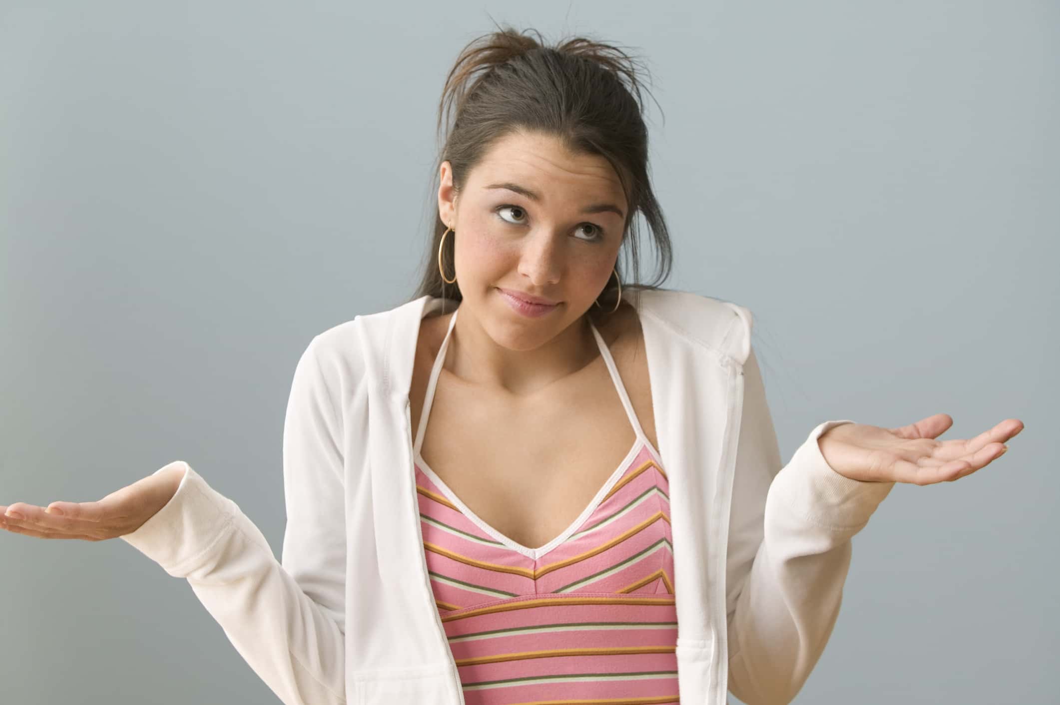 Teenage girl gesturing with palms up.