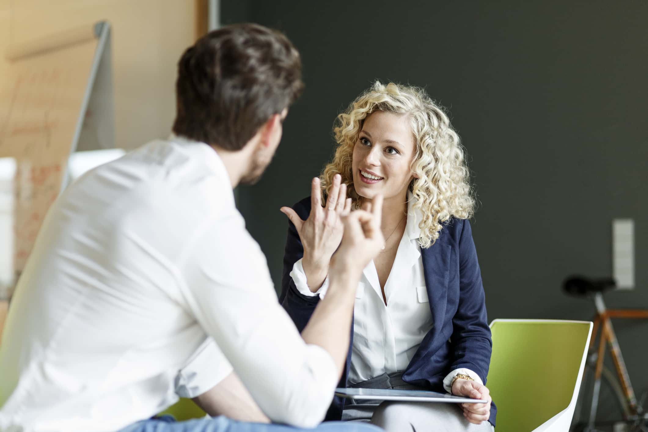 Two colleagues talking in office.
