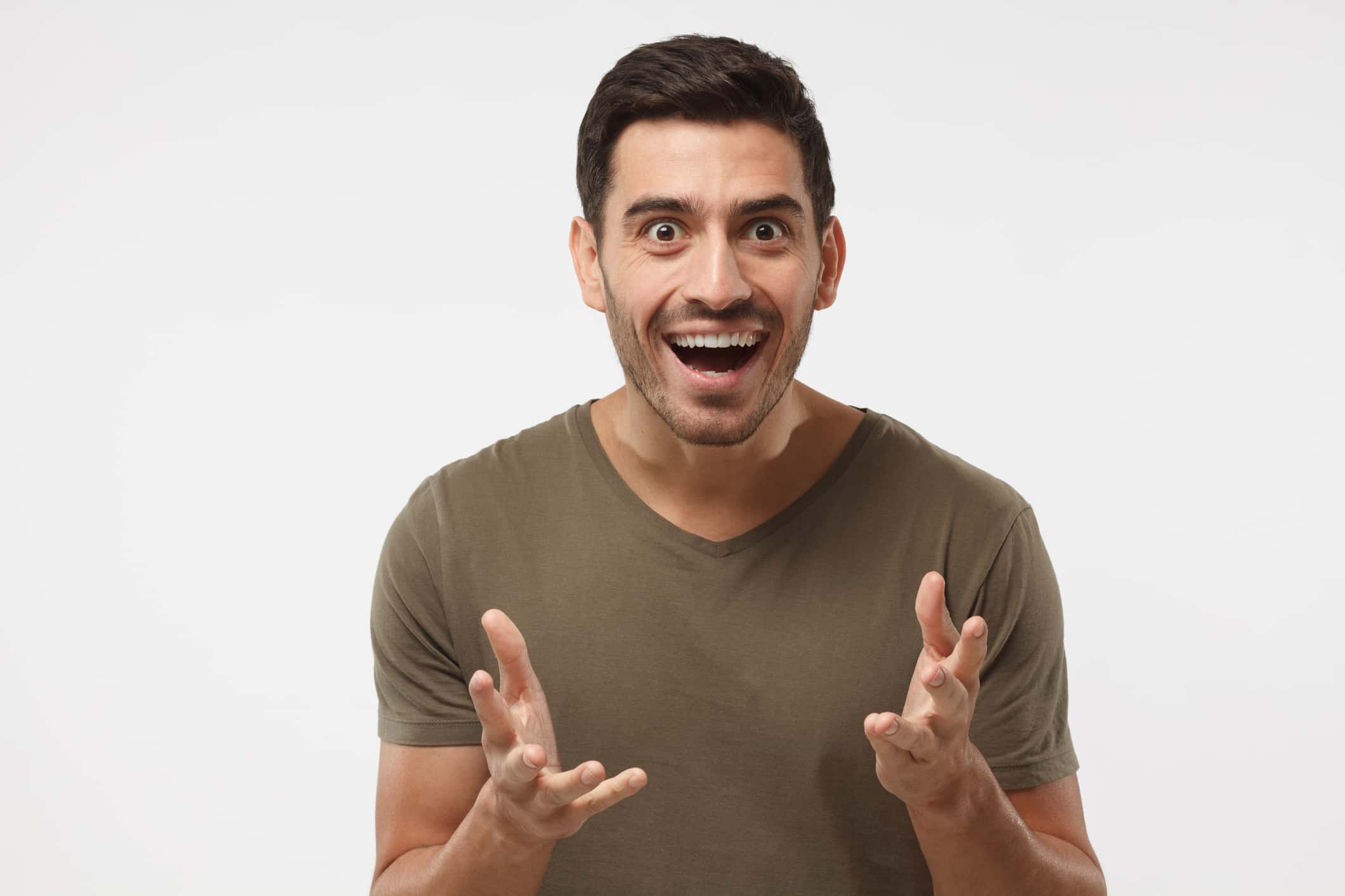 Crazy shocked young man, looking at camera with wide opened mouth.