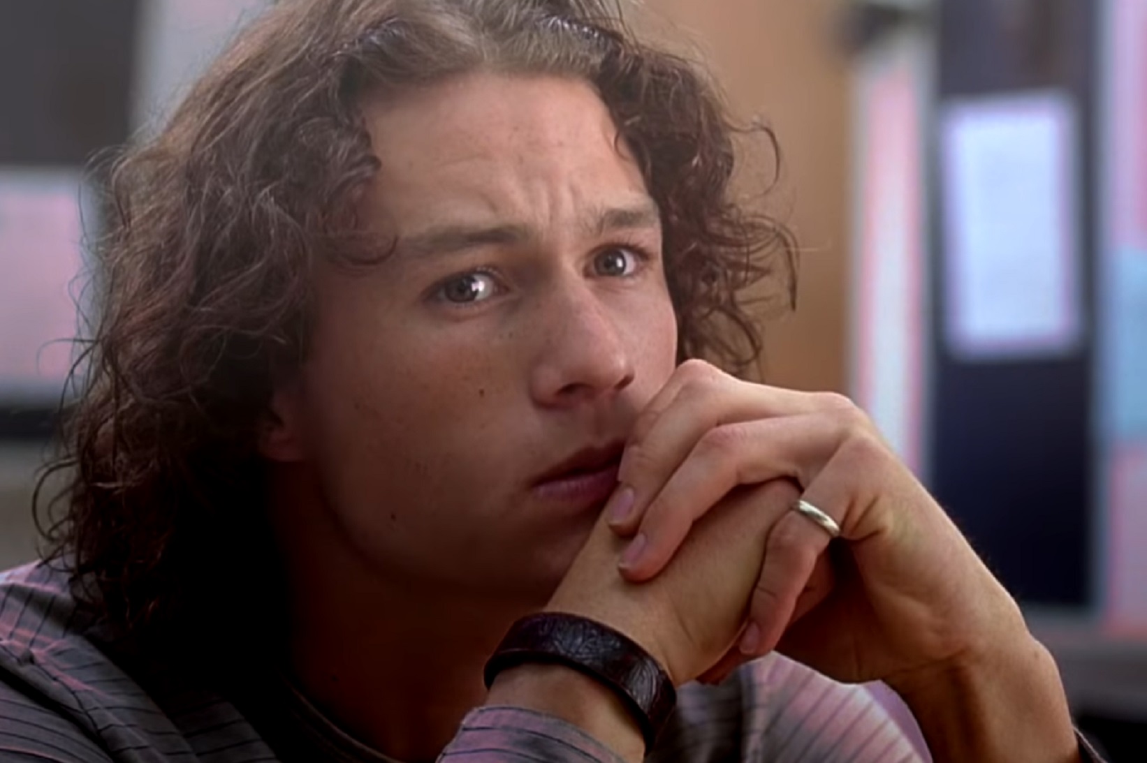 Screenshot: Heath Ledger with long hair wearing shirt