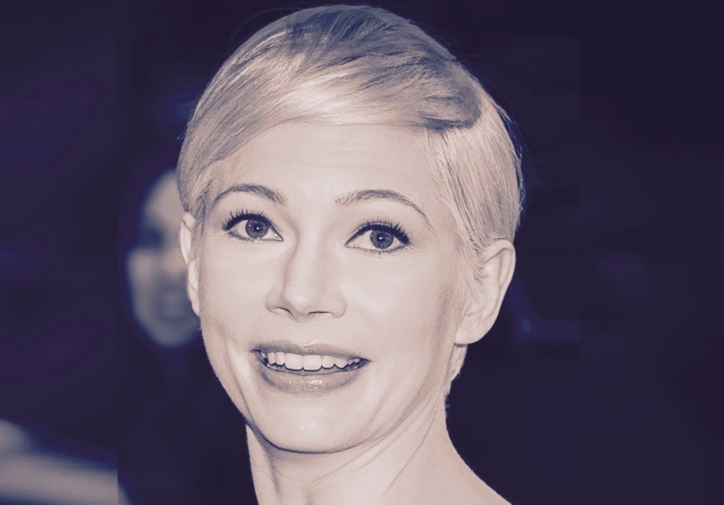 B&W Photo of Michelle Williams with blond hair smiling to a camera - 2016