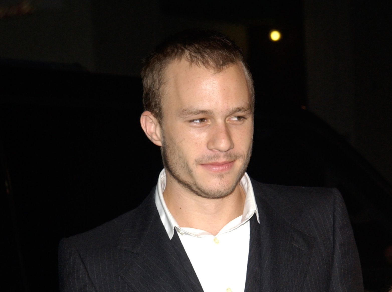 Heath Ledger with short hair wearing white shirt and black suit - 2002