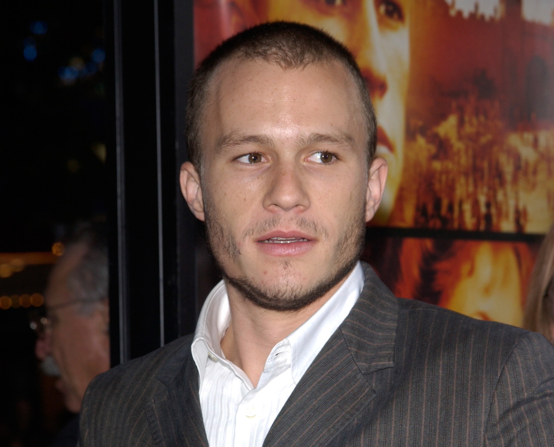 Photo of Heath Ledger wearing white shirt and grey jacket looking a side - 2002