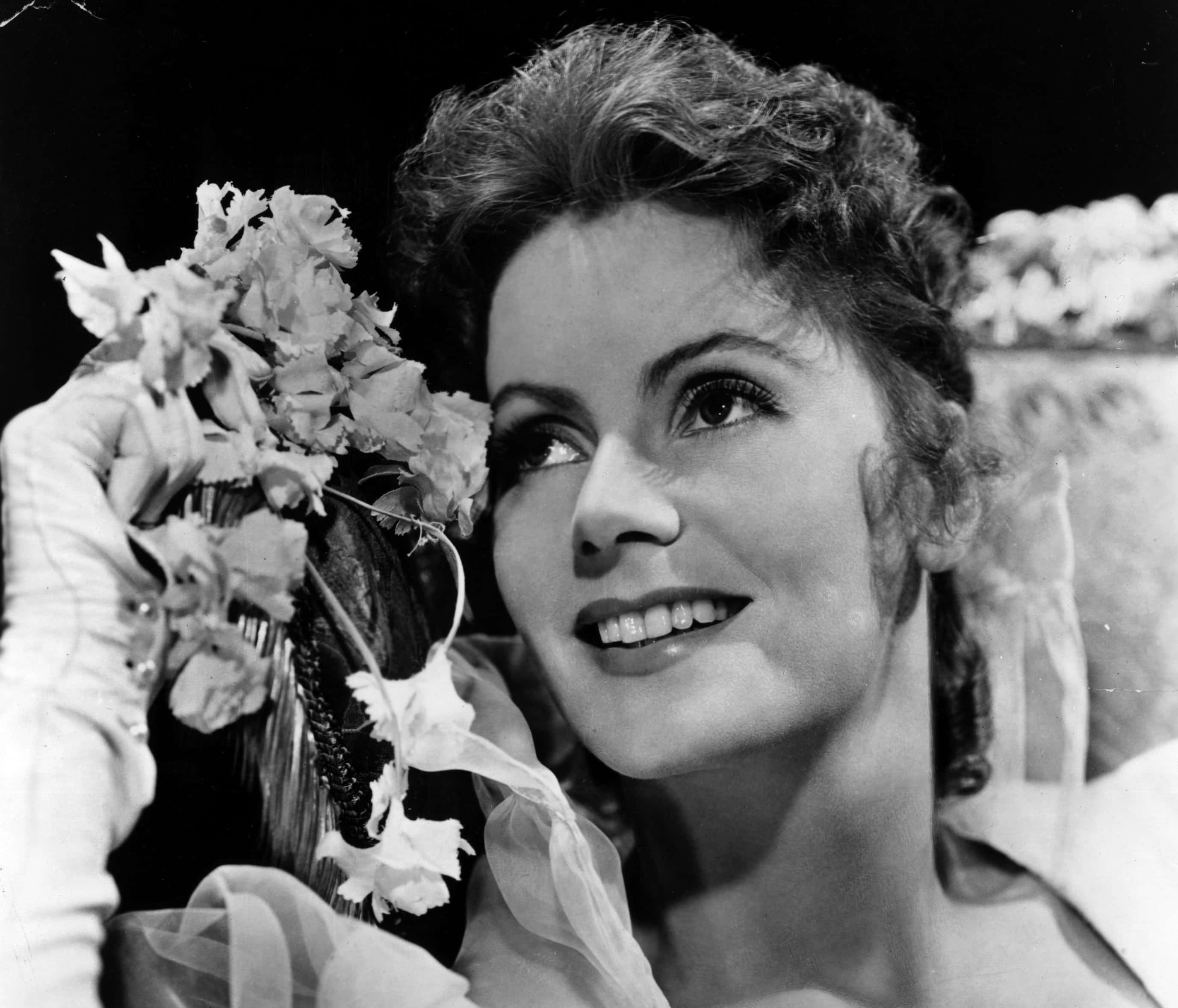Greta Garbo holding flowers
