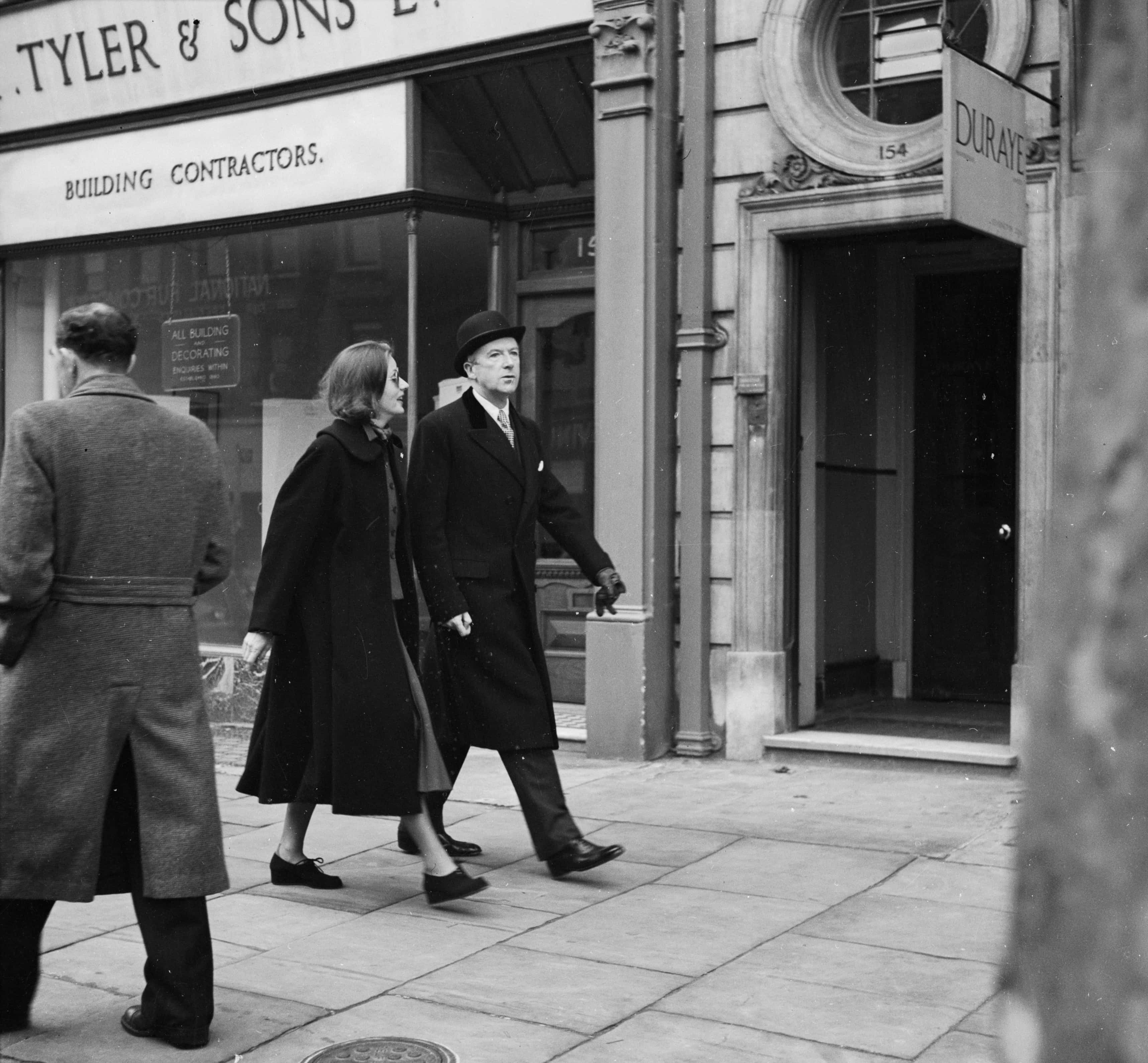 Greta Garbo in coat at street