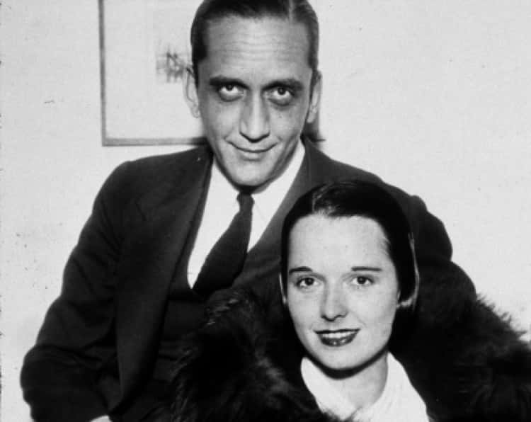 Louise Brooks & her husband Deering Davis, sitting next to each other, smiling, facing the camera