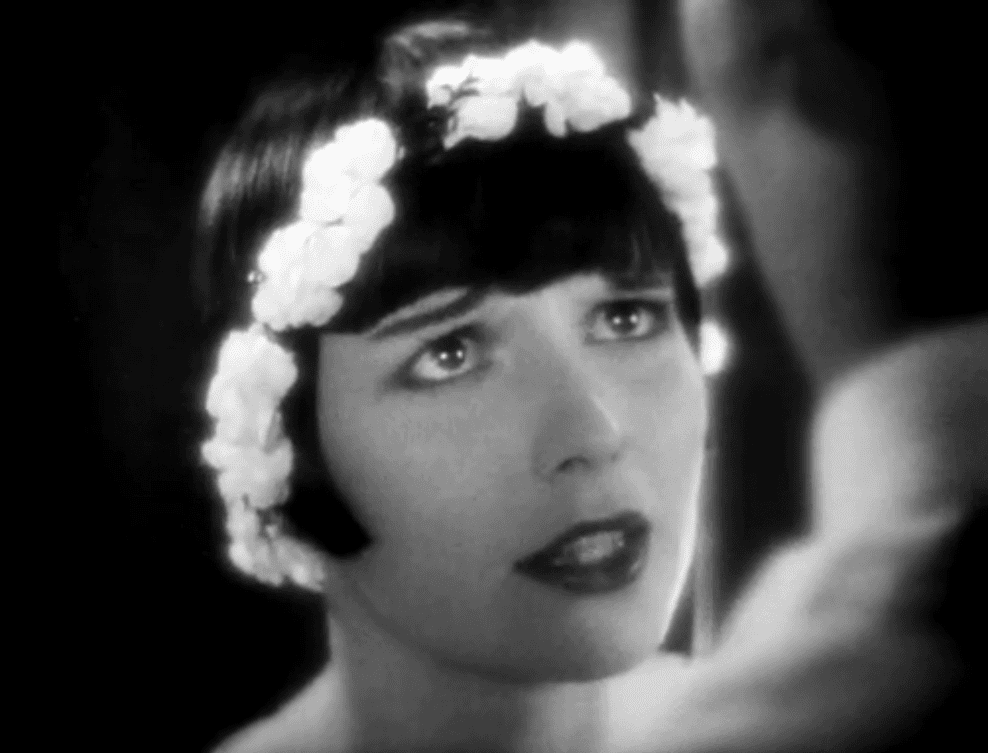 Grayscale Portrait Photo of the actress Louise Brooks from the movie Diary of a Lost Girl, wearing flower on her hair