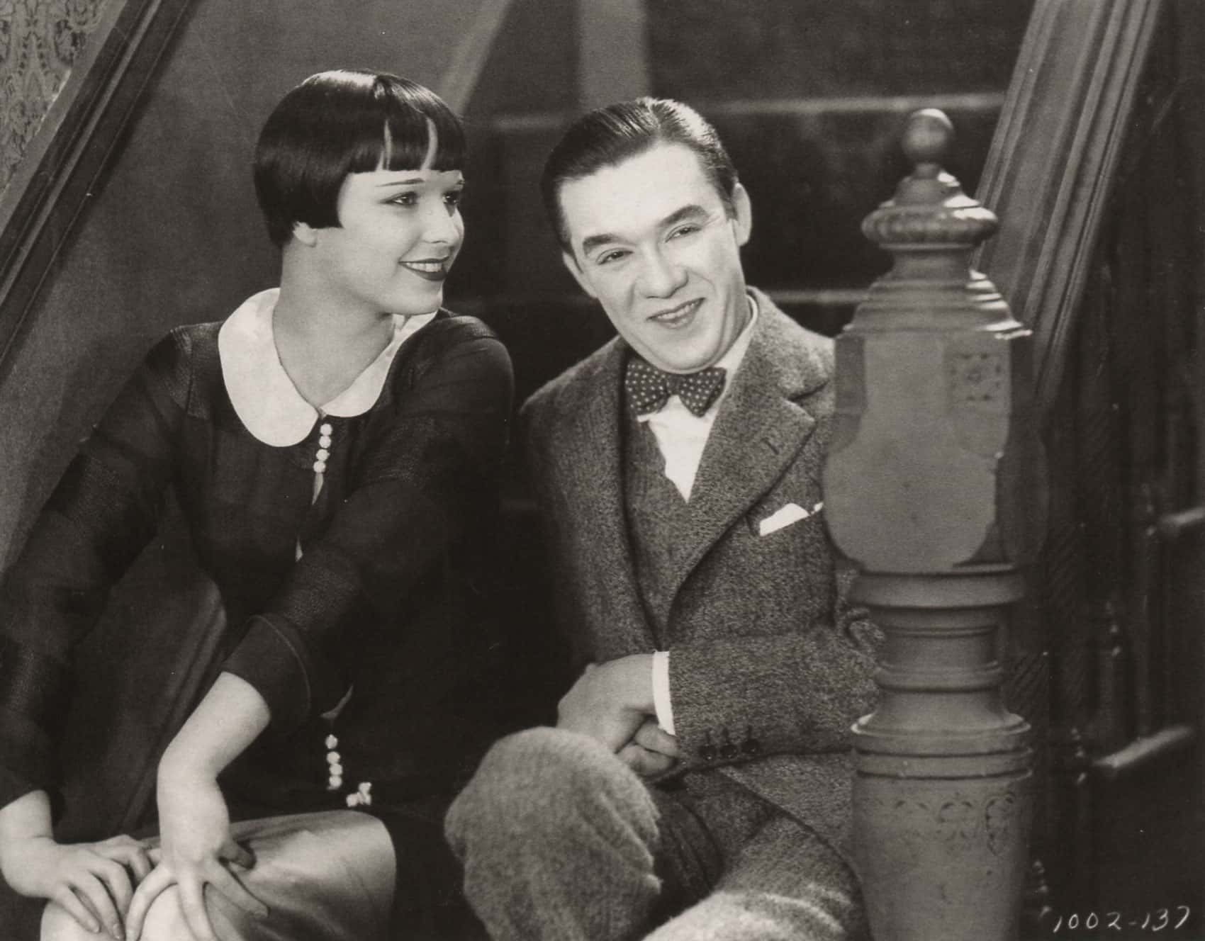  Louise Brooks and Gregory Kelly in the movie The Show Off, sitting next to each other