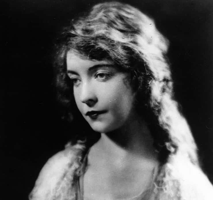 Lillian Gish in lace dress looking at left