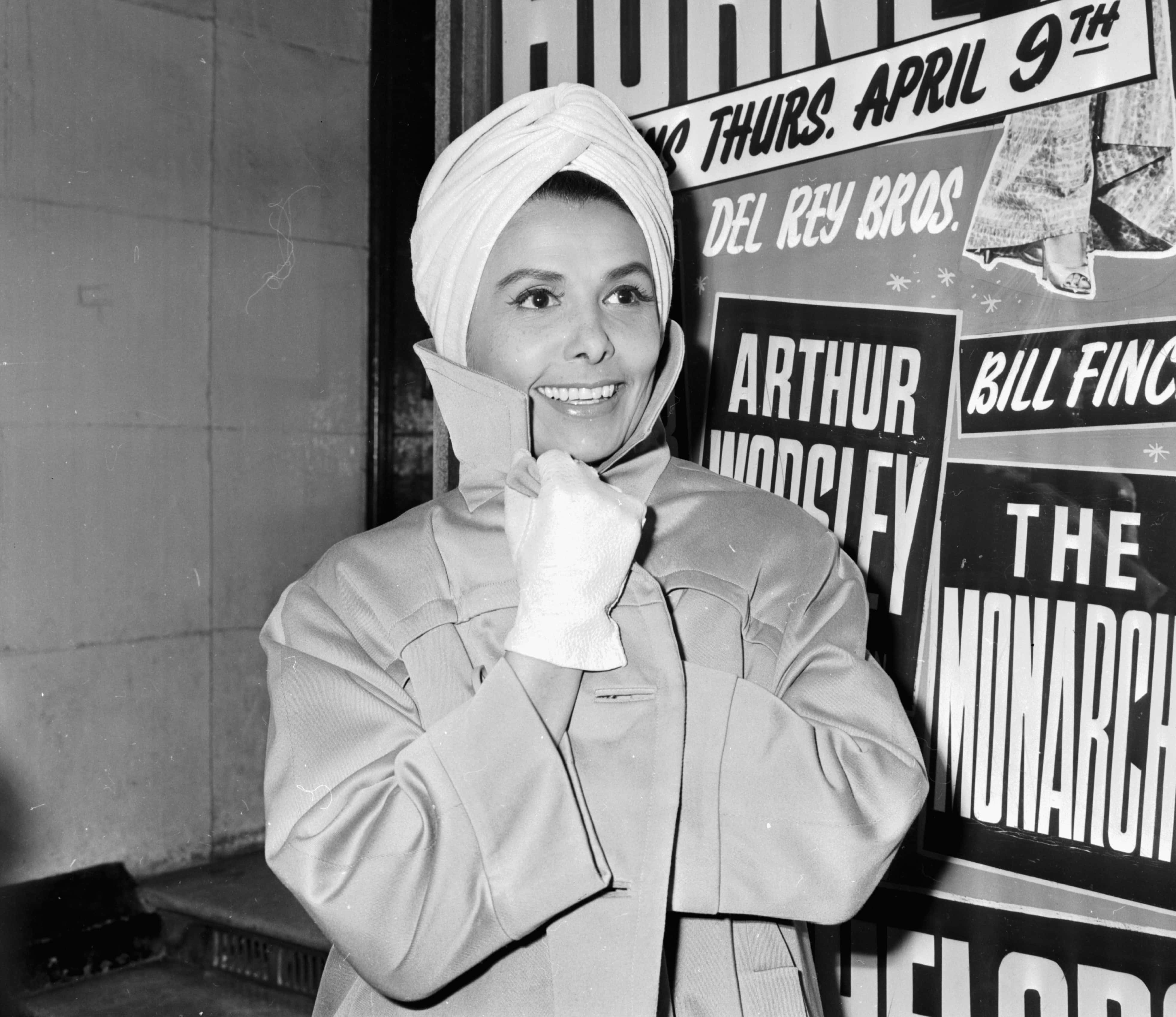 Singer Lena Horne, wearing a turban and winter coat,