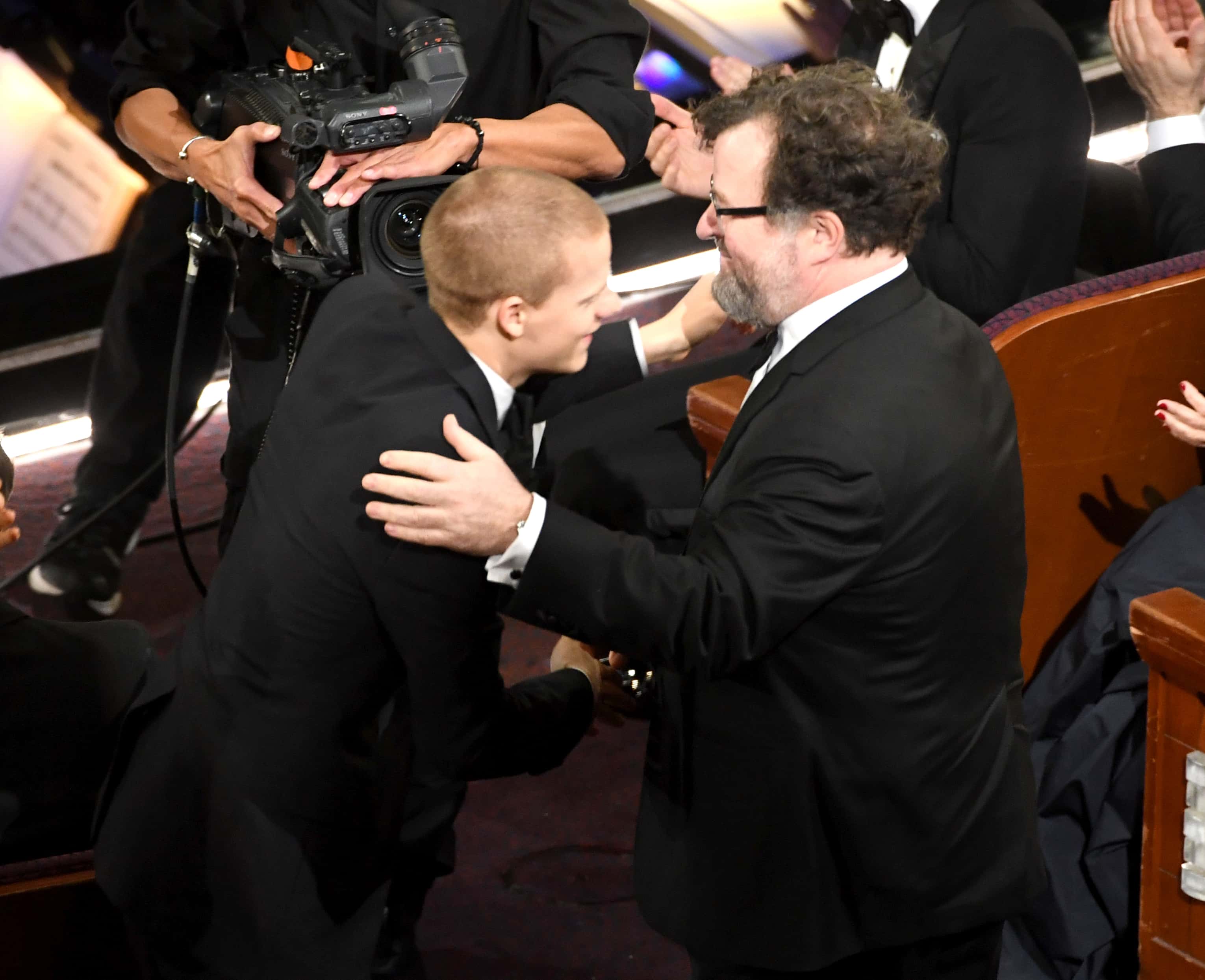 Actor Lucas Hedges and writer/director Kenneth Lonergan shake hands during the 89th Annual Academy Awards