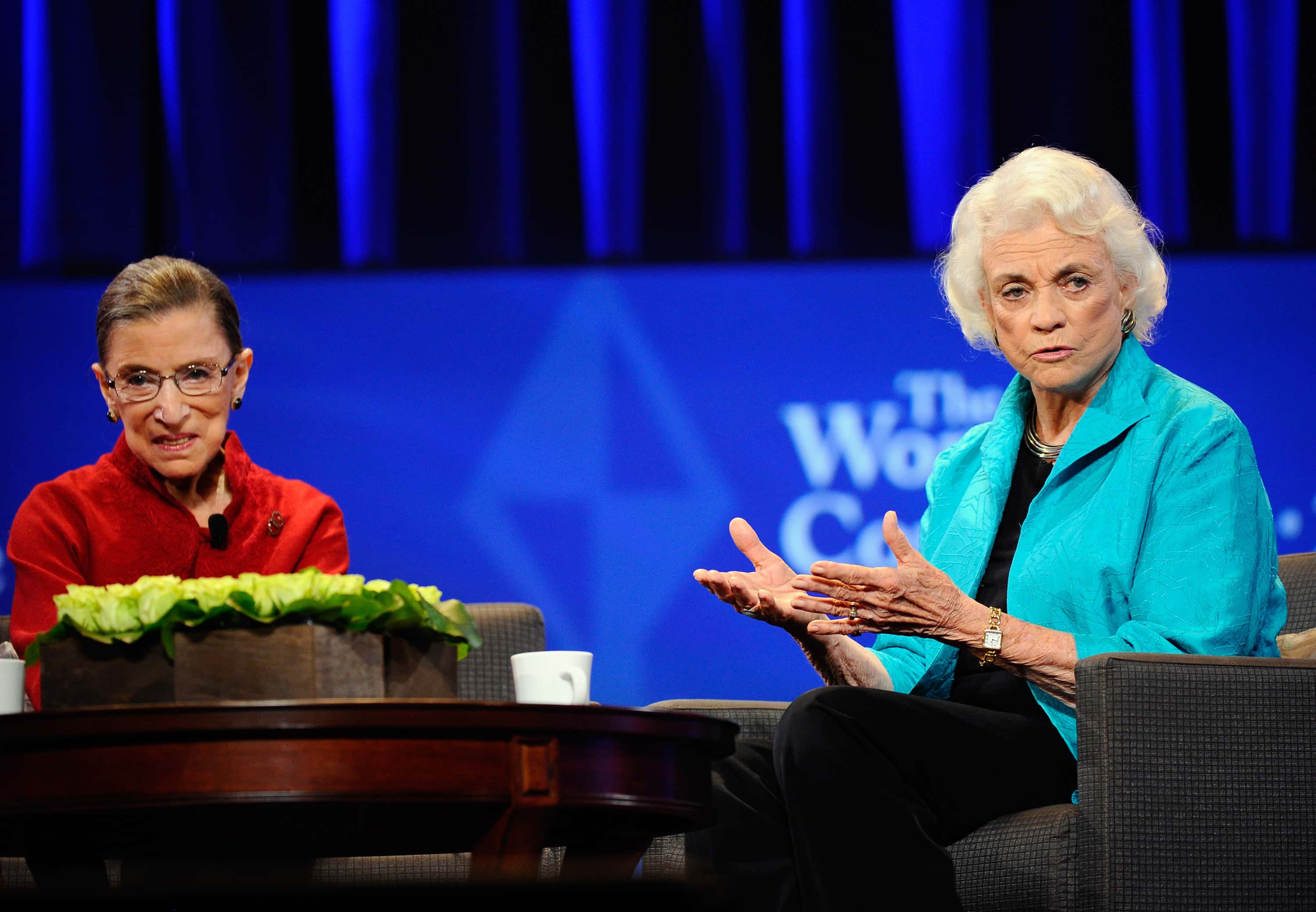 Justice Ruth Bader Ginsburg (L) and former justice Sandra Day O'Connor attend California first lady Maria Shriver's annual Women's Conference 2010 sitting at a table speaking