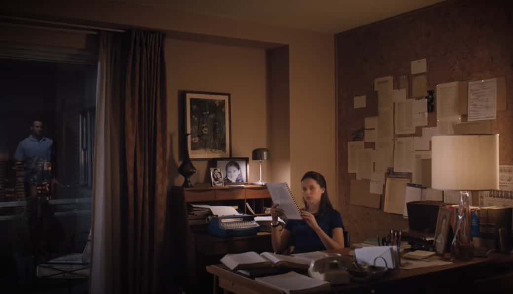 Felicity Jones as Ruth Bader Ginsburg in blue suit working at office