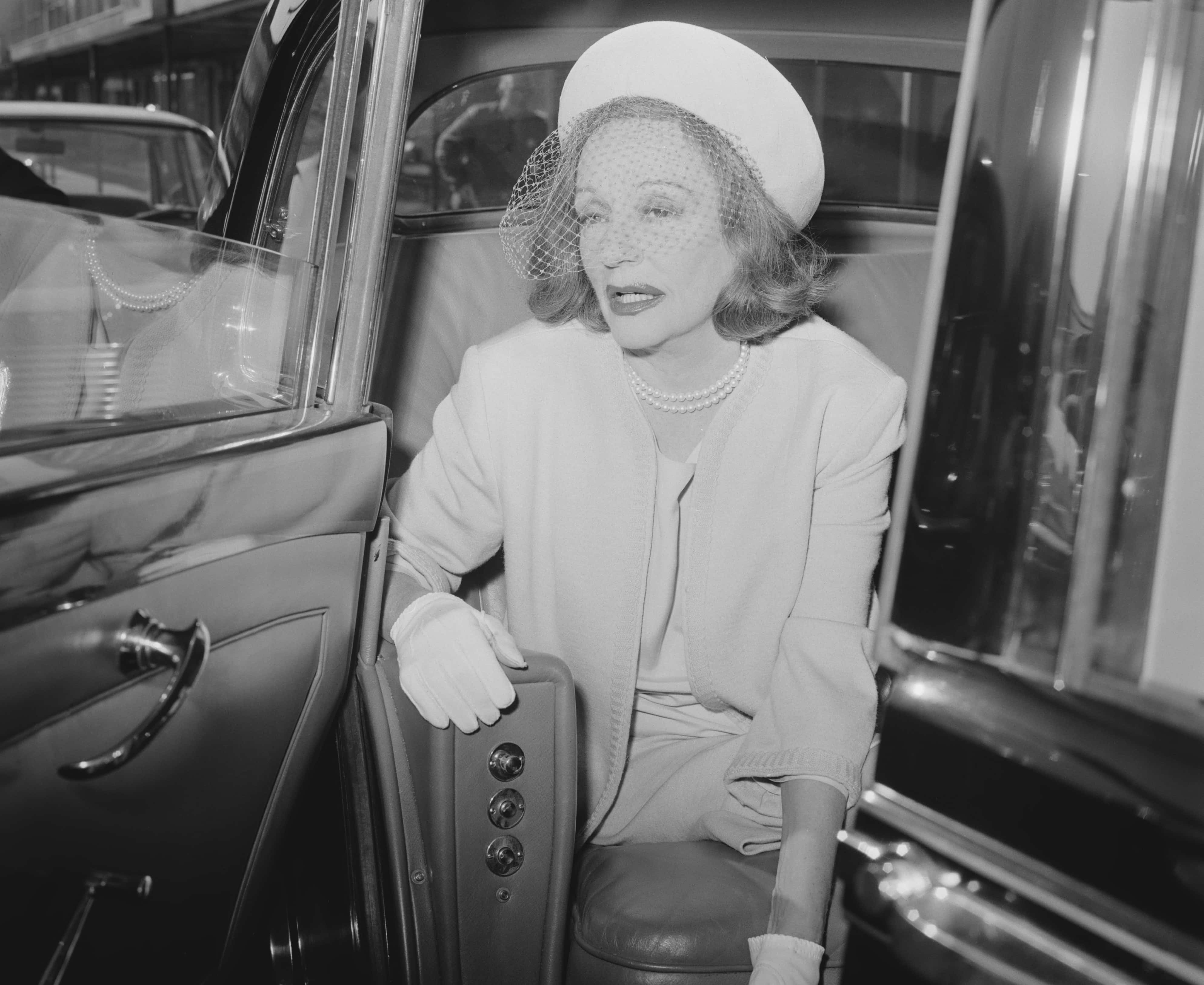Tallulah Bankhead getting out of  a car
