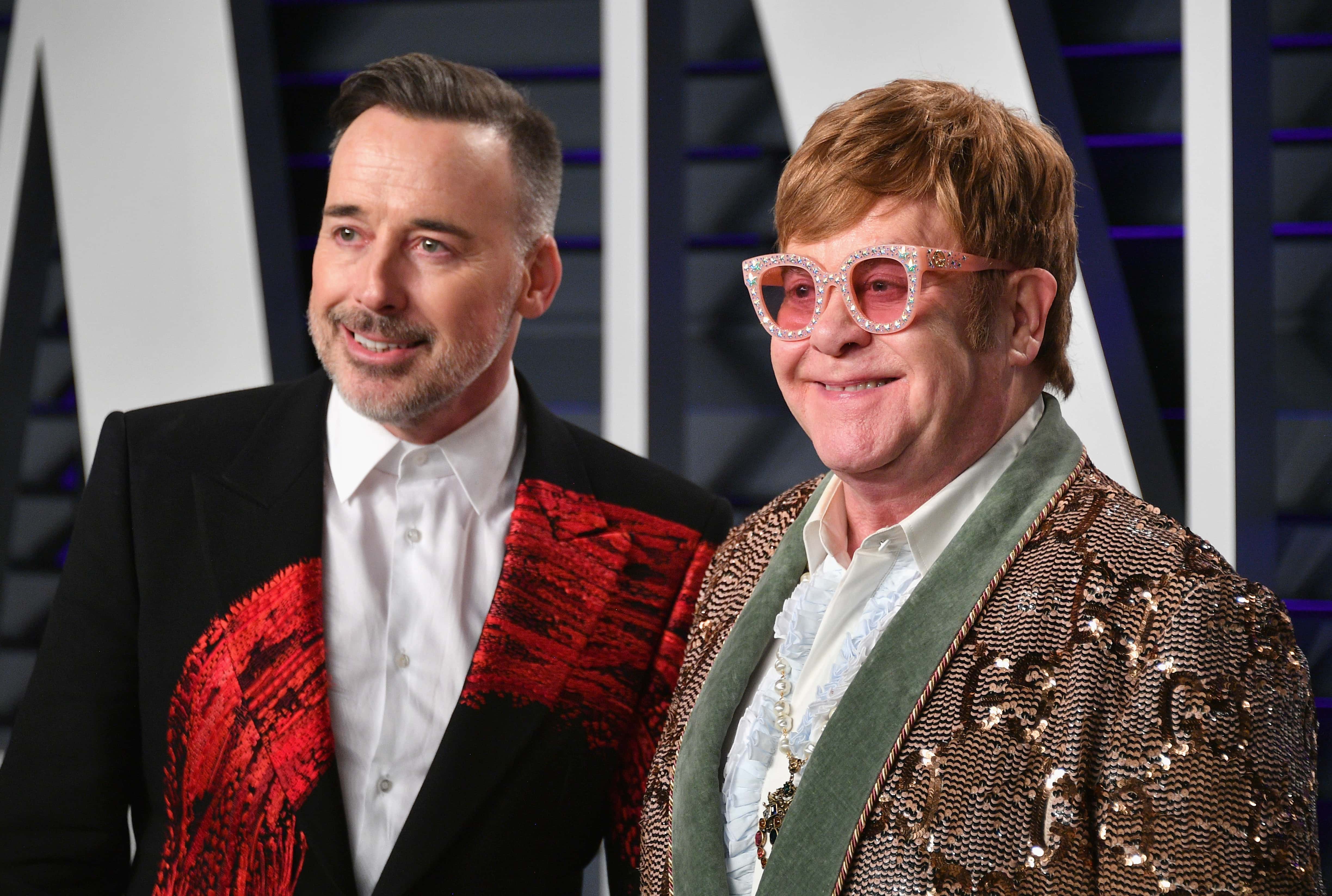 David Furnish (L) and Elton John attend the 2019 Vanity Fair Oscar Party hosted by Radhika Jones - 2019