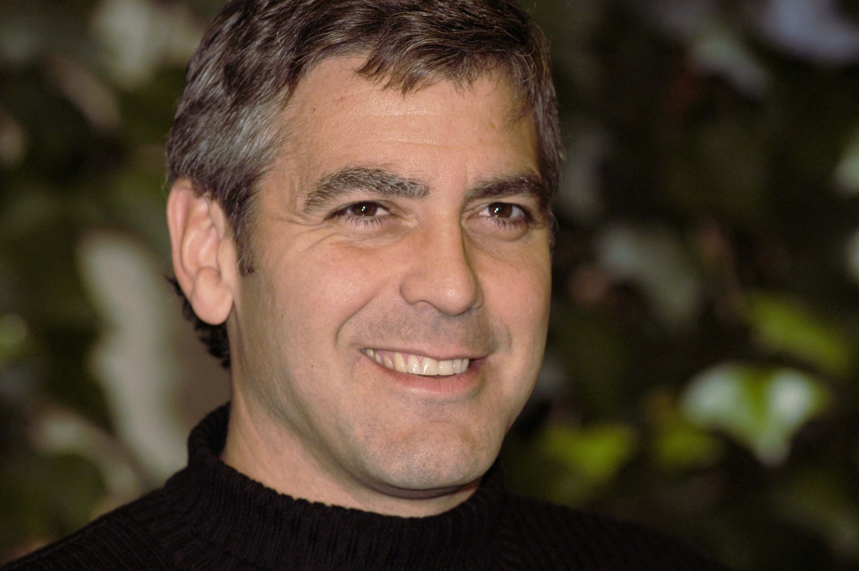 Director George Clooney poses for photographers