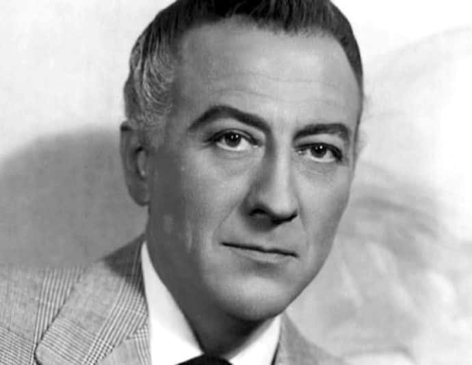 american actor John Emery in gray suit