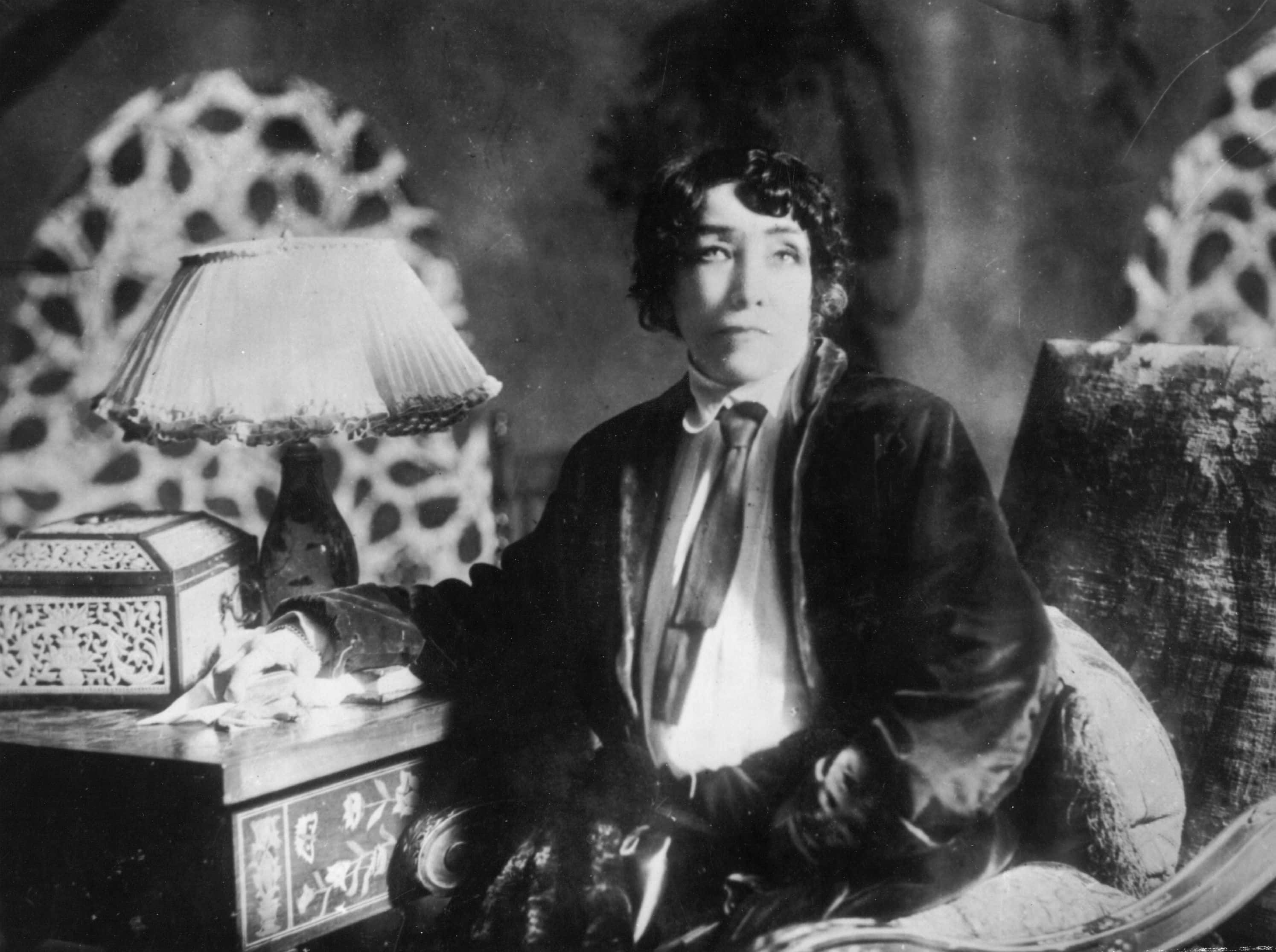 Sarah Bernhardt  sitting at a desk 