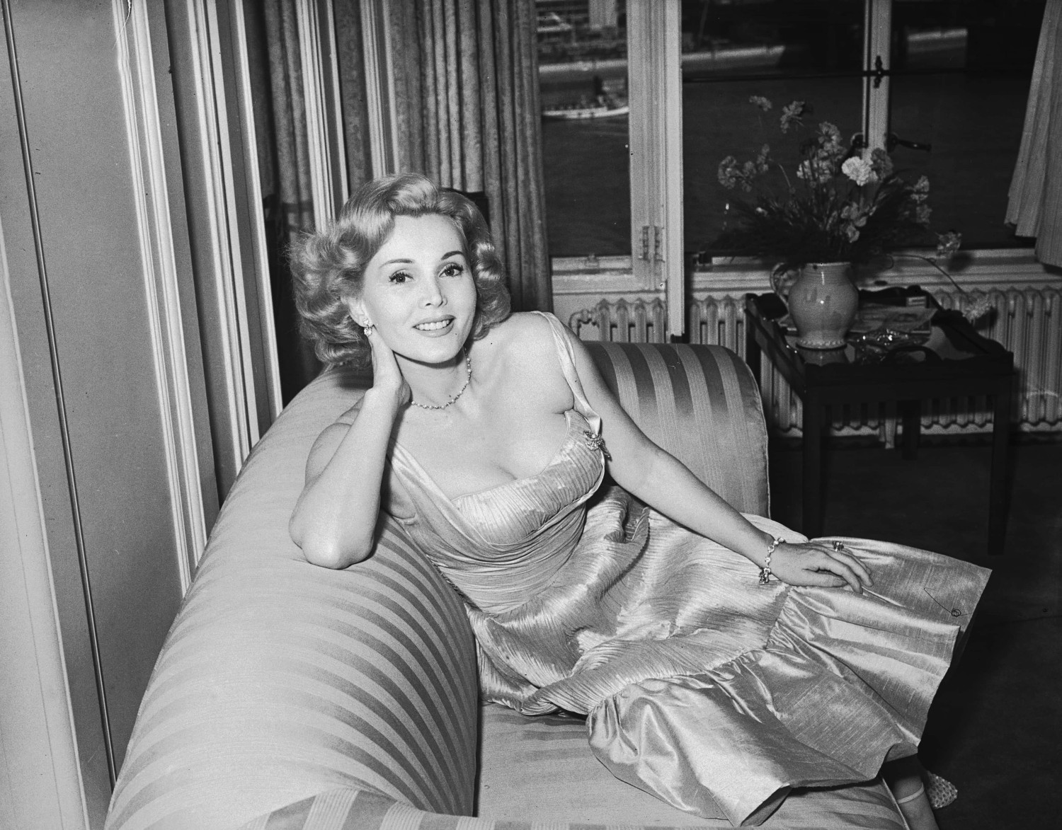 Zsa Zsa Gabor sitting on a couch