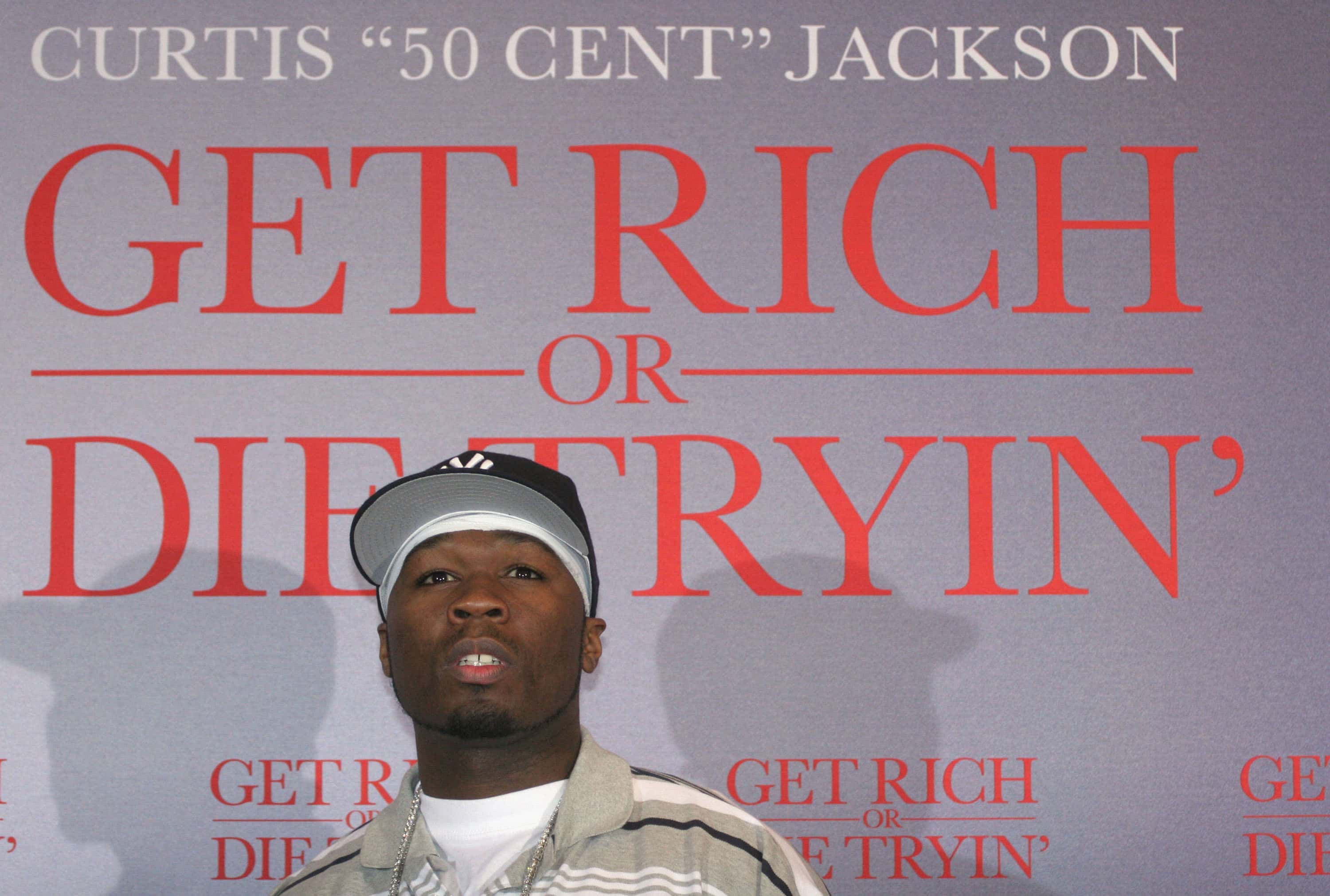 50 Cent poses at a photocall for his movie "Get Rich or Die Tryin"