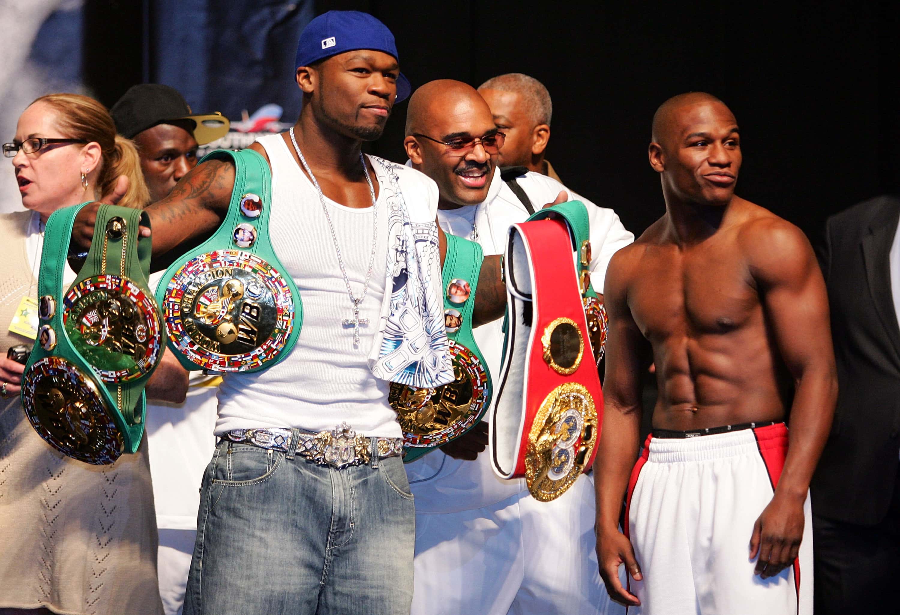 Rapper 50 Cent holds up Floyd Mayweather Jr. belts