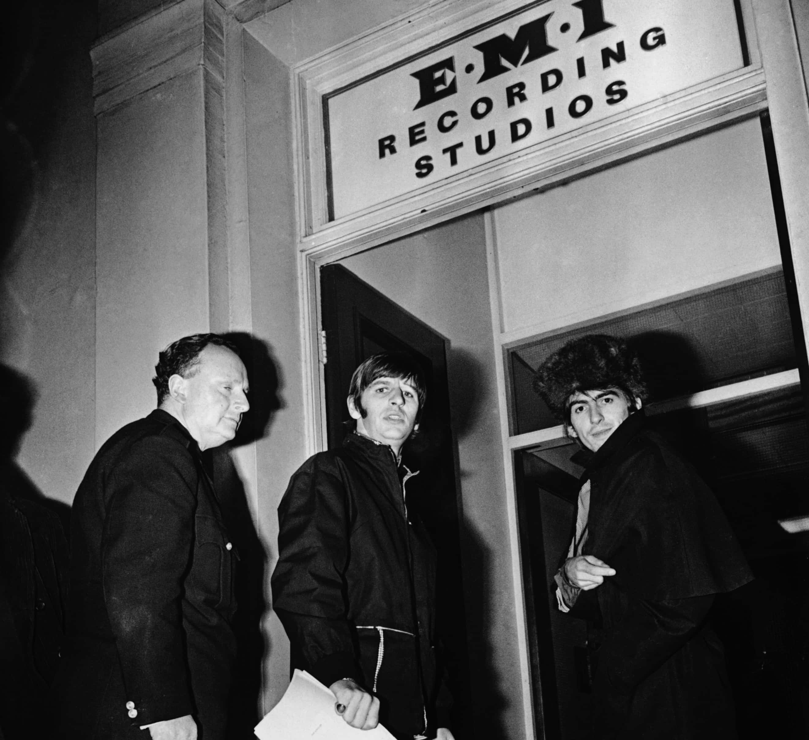 Ringo Starr and George Harrison (1943 - 2001) of the Beatles arrive at the EMI recording studios