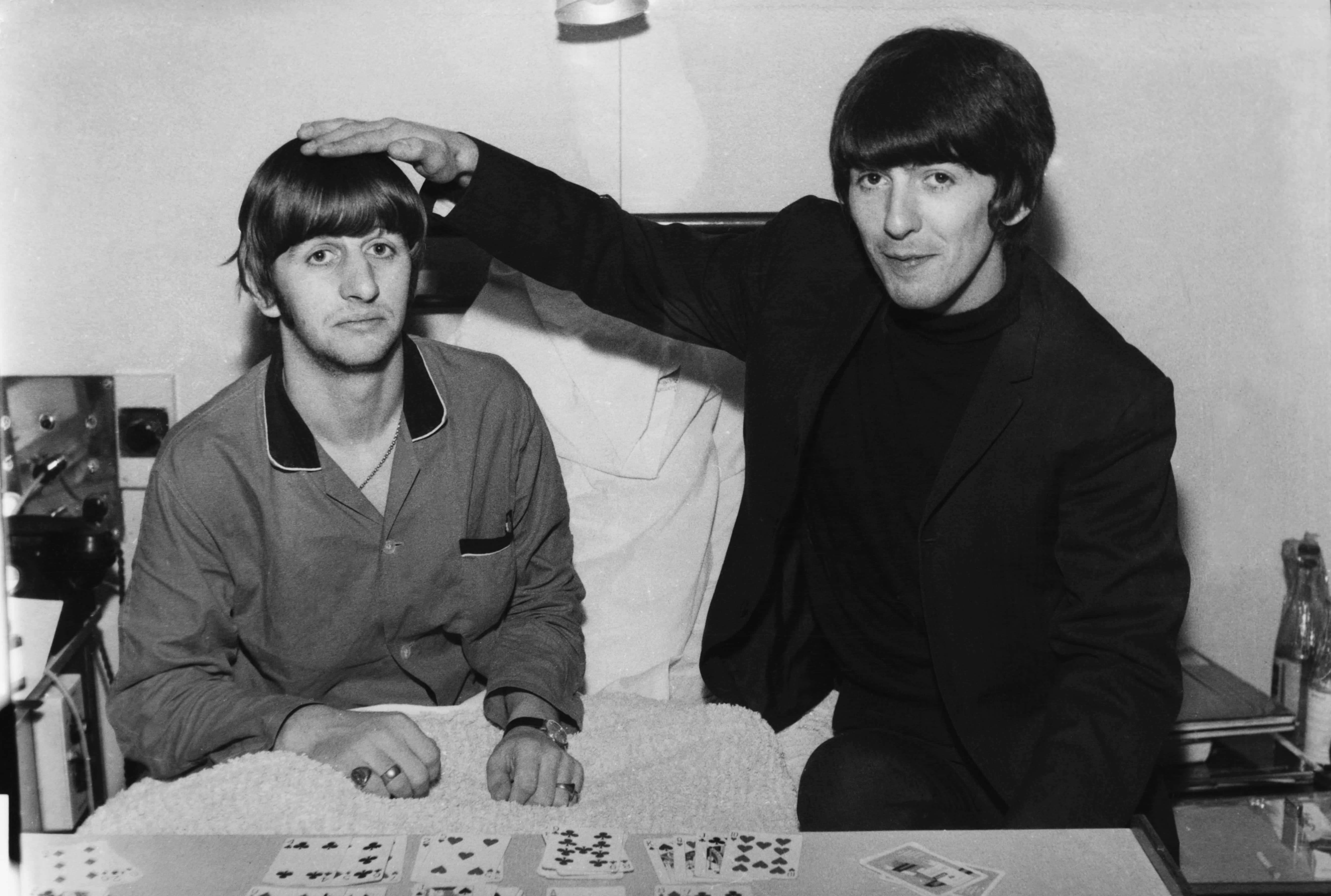 Drummer Ringo Starr (left) gets a visit from fellow Beatle George Harrison (right) whilst recuperating from an operation