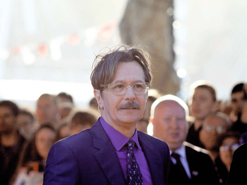Gary Oldman wearing a purple shirt