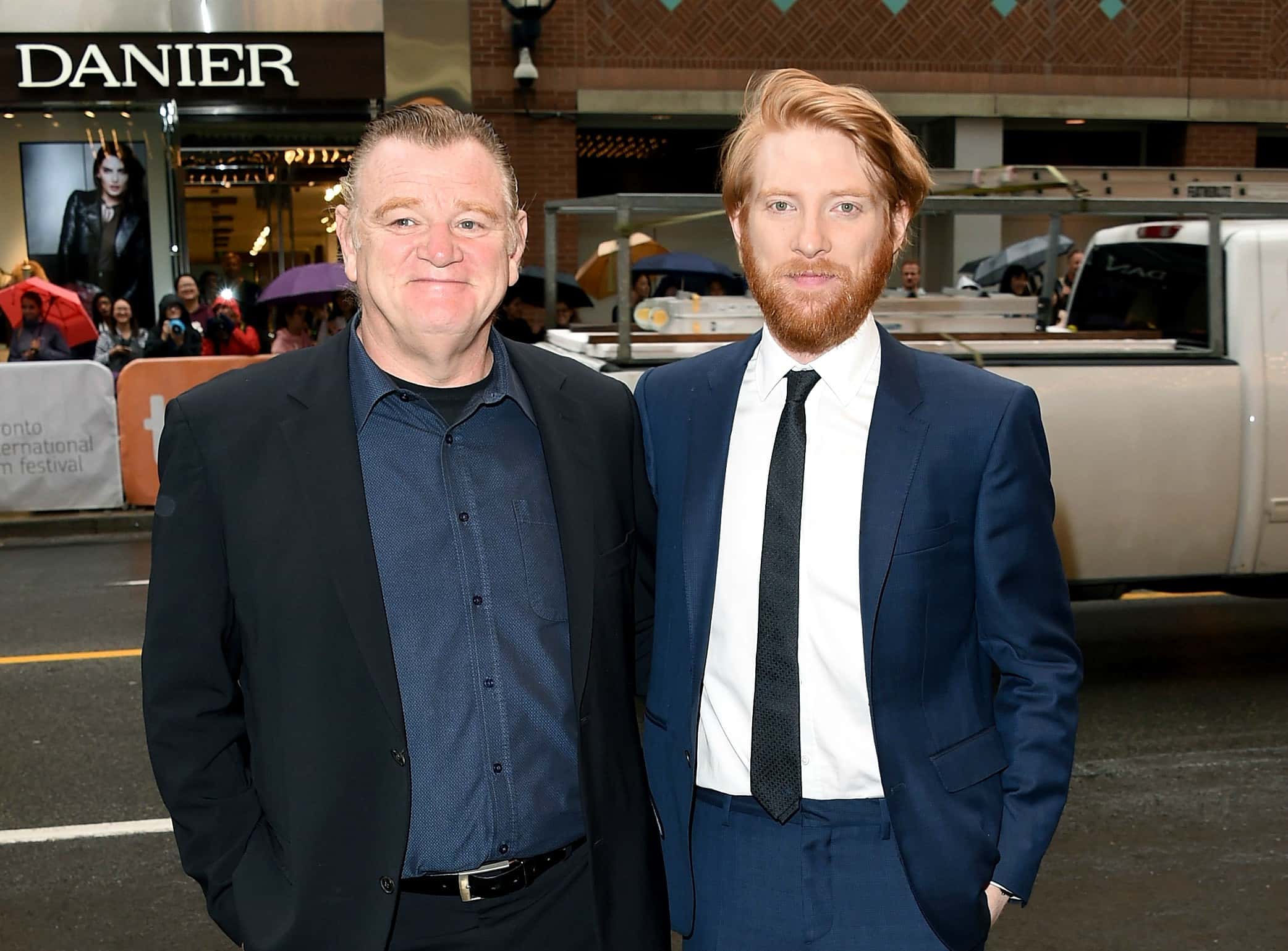 Actors Brendan Gleeson and Domhnall Gleeson in suits