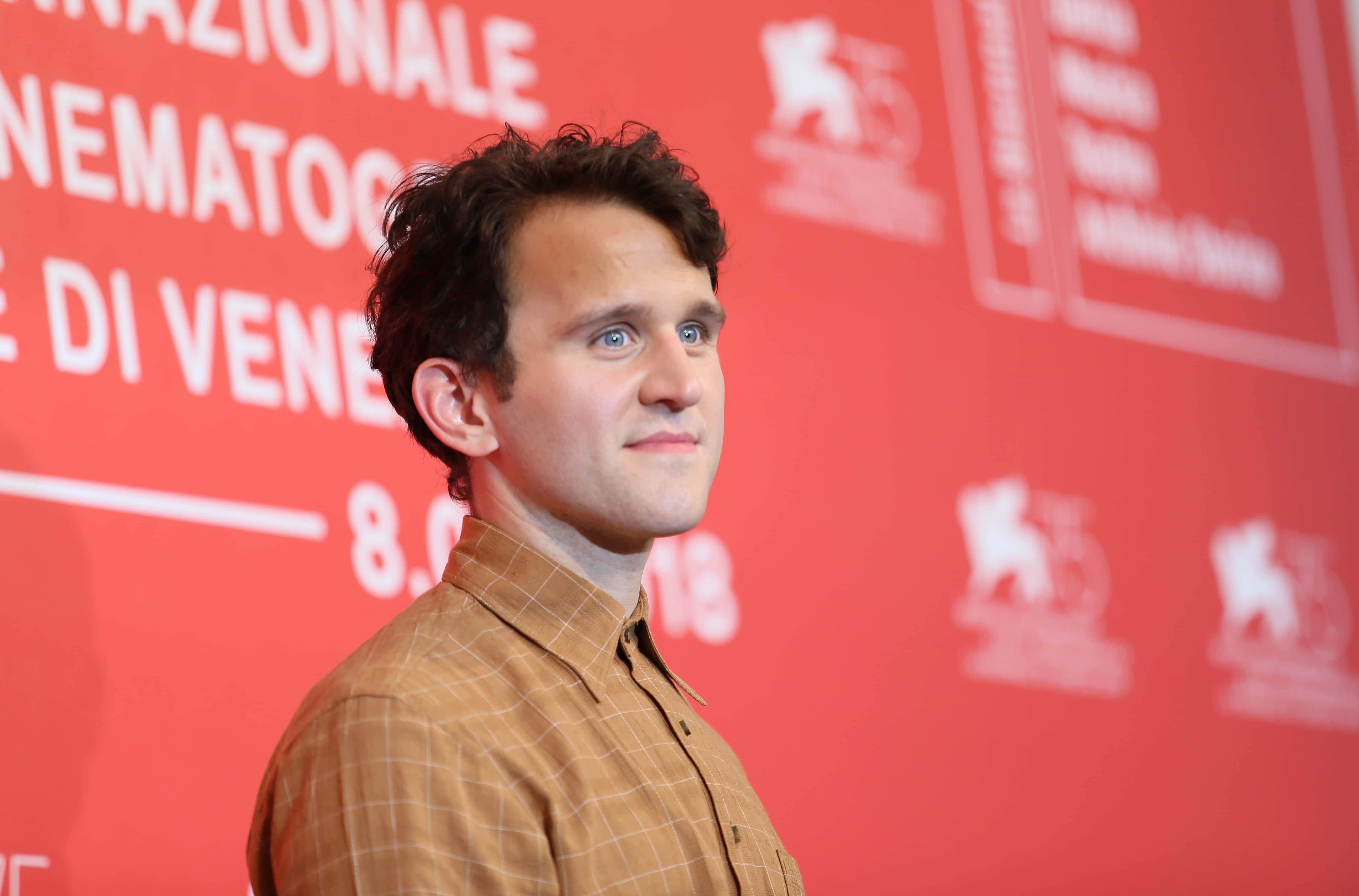 Harry Melling earing a yellow shirt