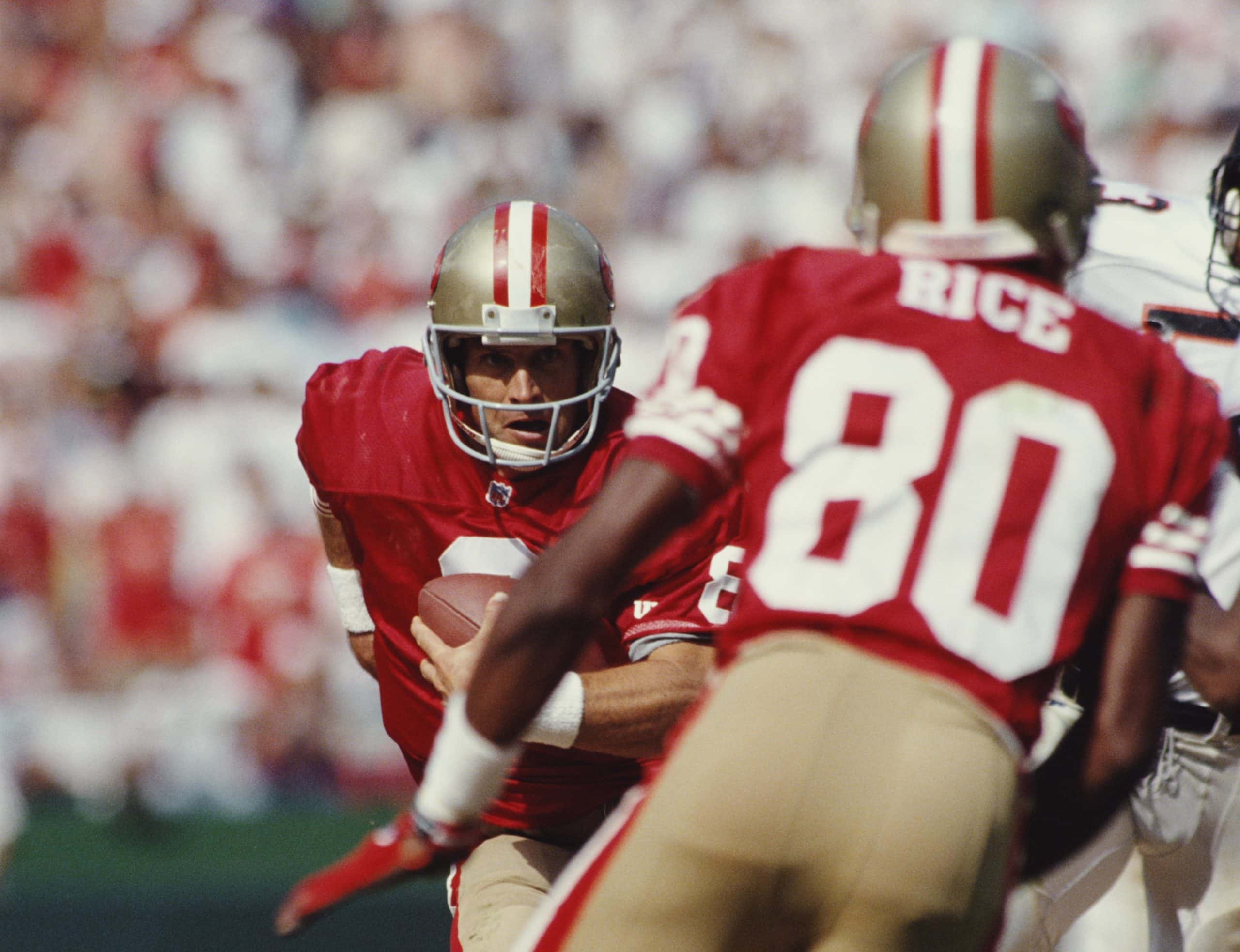 Steve Young #8, Quarterback for the San Francisco 49ers keeps his eye on his wide receiver #80 Jerry Rice