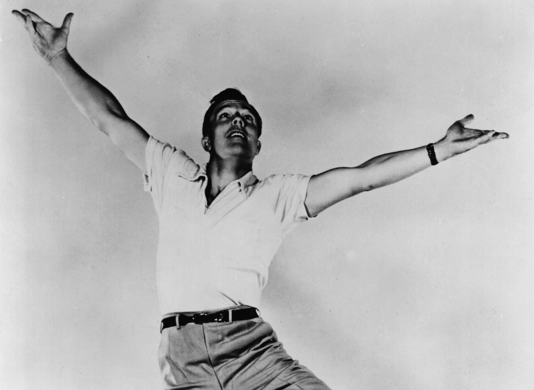 Gene Kelly dancing in studio looking up