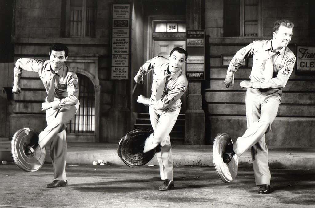 Michael Kidd, Gene Kelly and Dan Dailey in uniforms dancing