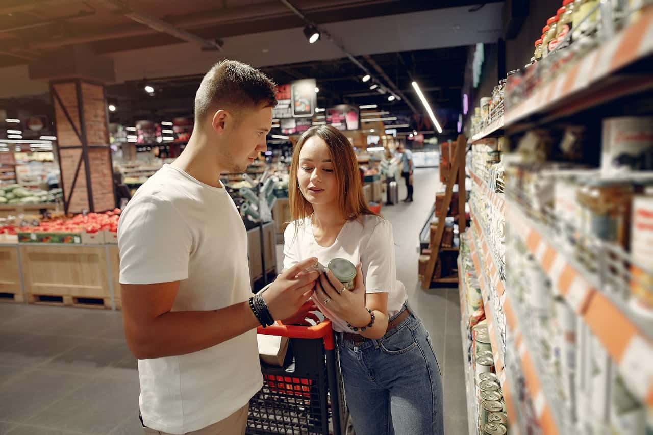 Couple shopping groceries in market.