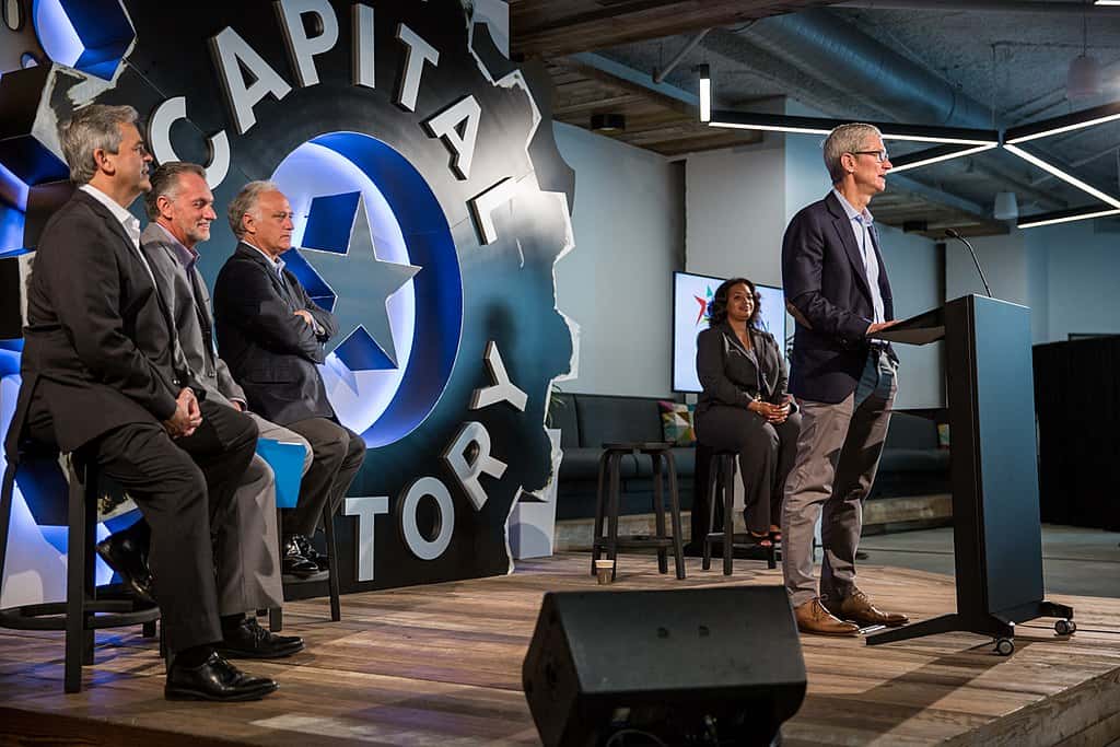 Apple CEO Tim Cook speaking in front of members