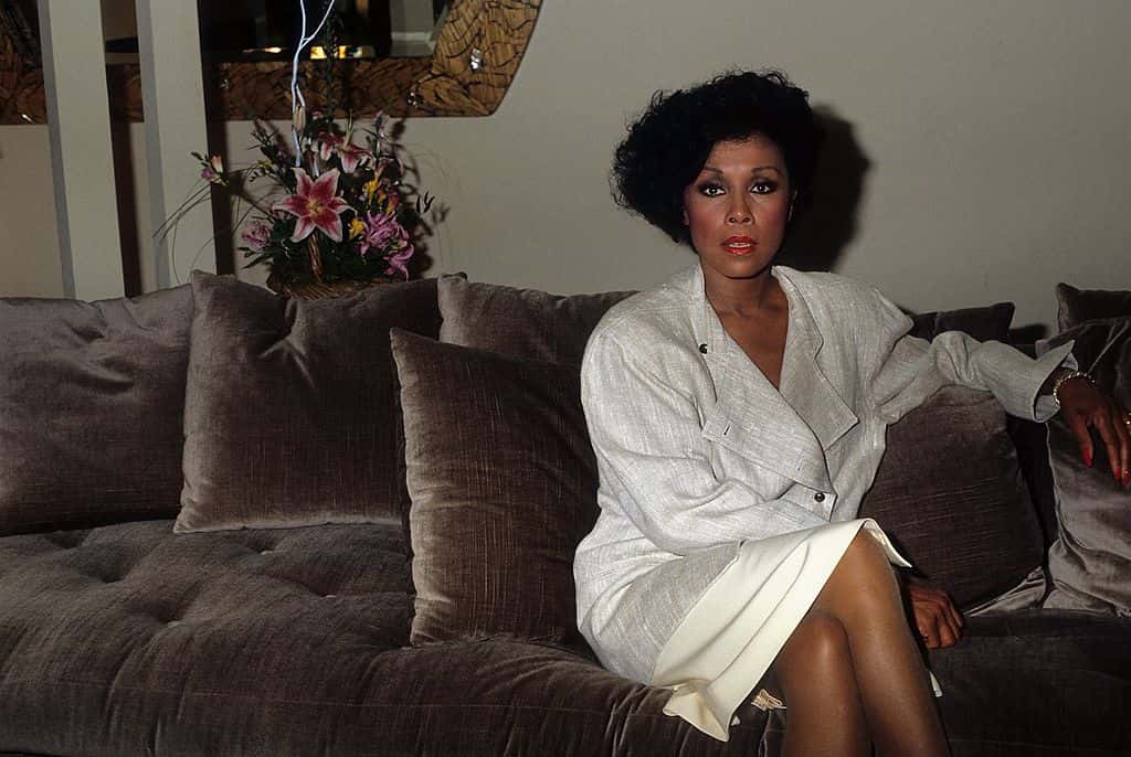 Actress Diahann Carroll poses for a portrait sitting on a couch