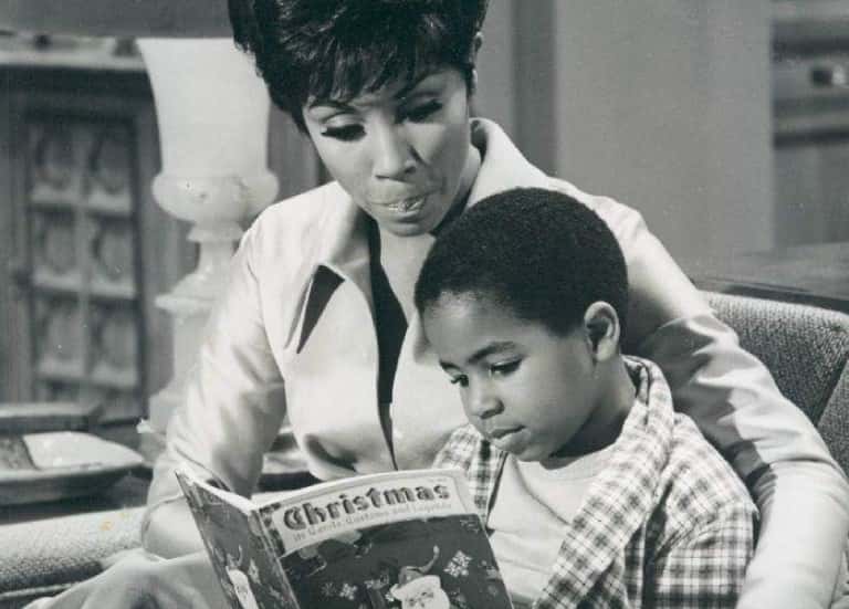 Publicity photo of Diahann Carroll and Marc Coppage from Julia television program sitting next to each other