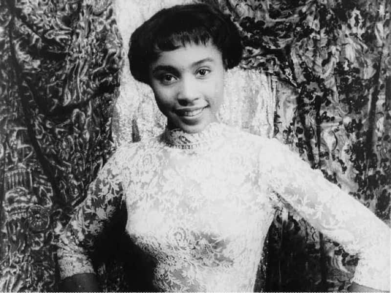 Portrait of the young Actress Diahann Carroll wearing a white dress