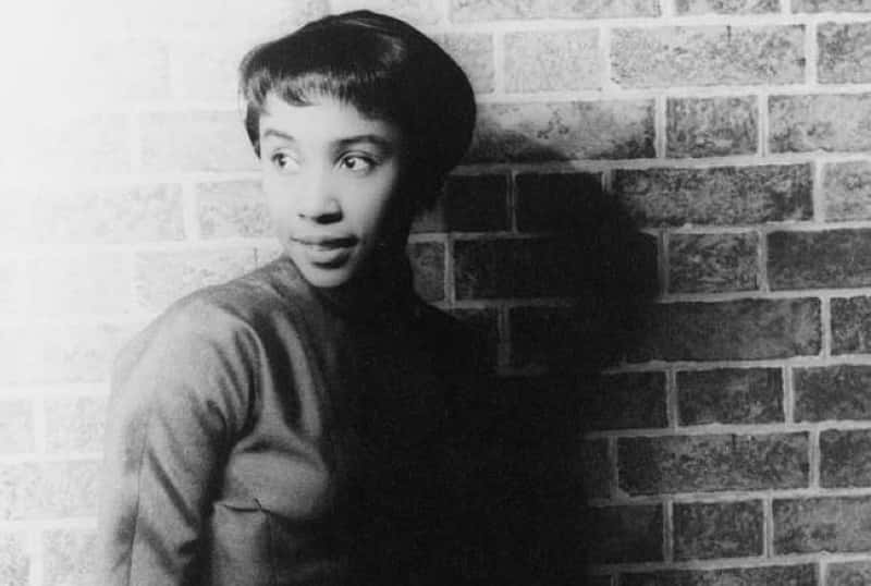 Portrait of the young actress Diahann Carroll wearing dark clothes
